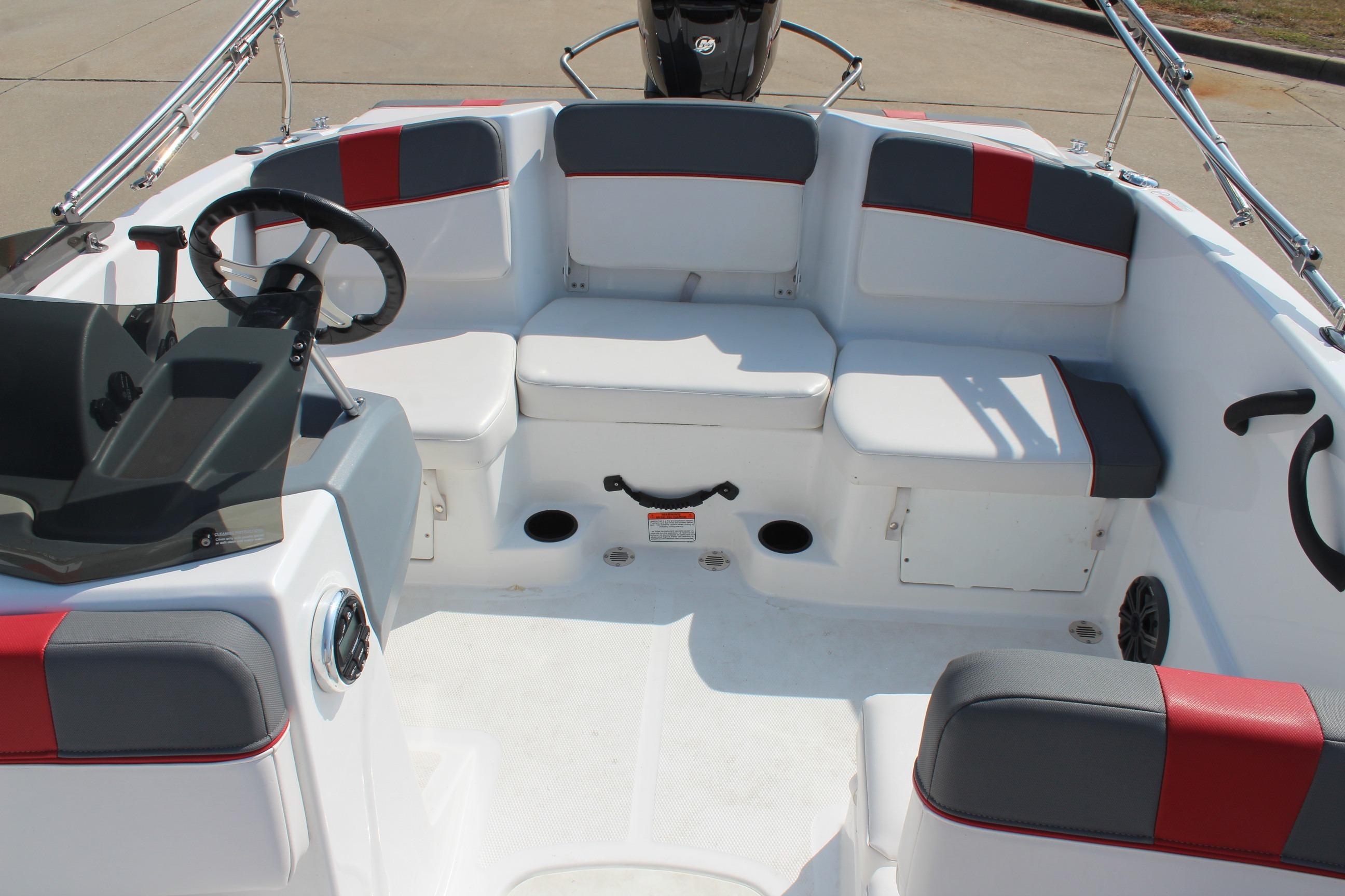 2023 Tahoe T16 boat interior with seating and steering wheel, featuring red and gray accents.