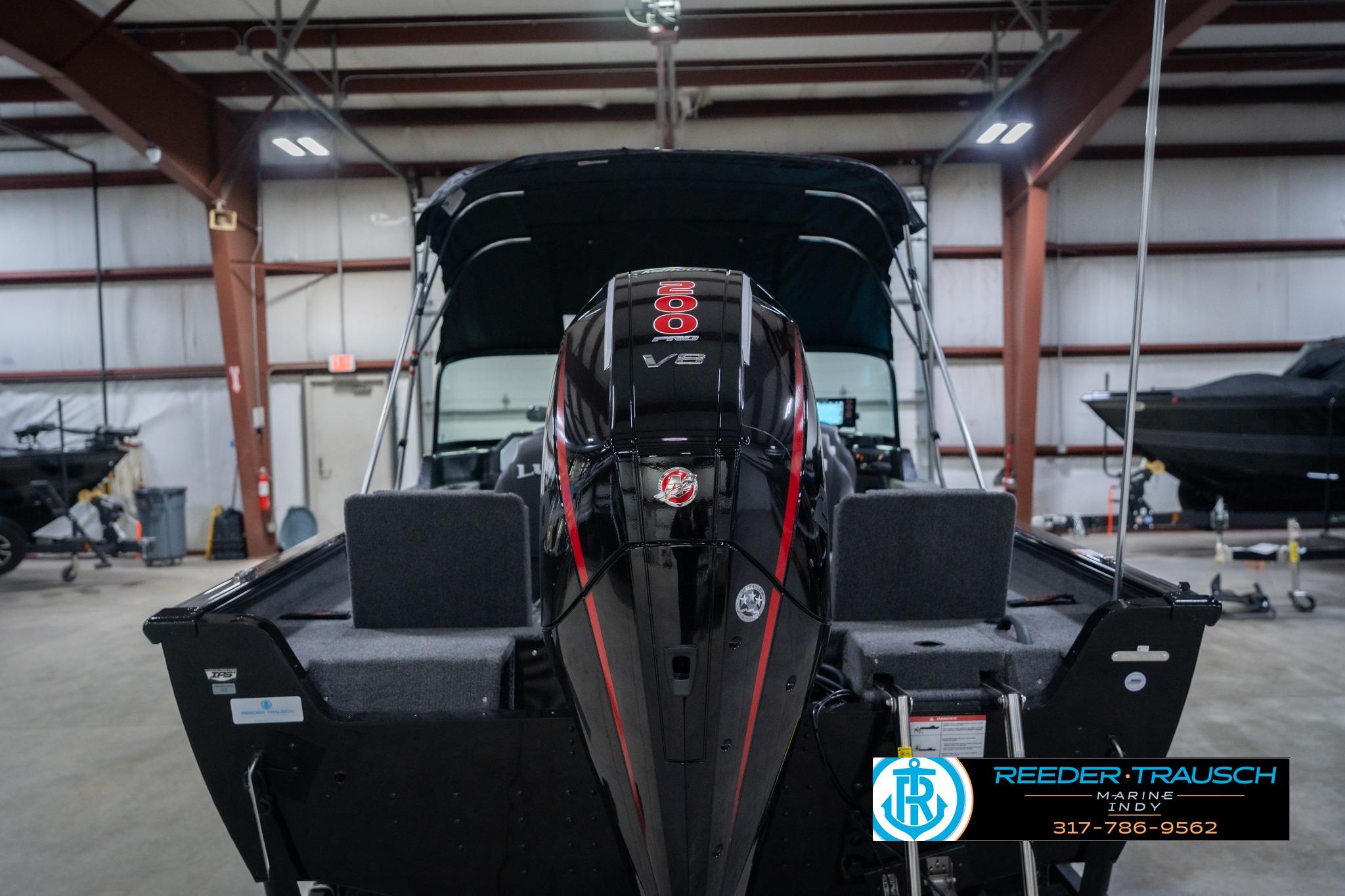 2026 Lund 2075 Impact XS boat with powerful V8 engine in indoor showroom.
