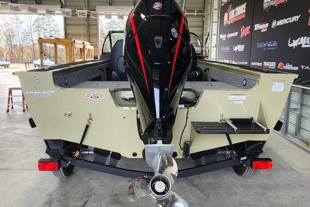 2026 Tracker Targa 185 WT boat with powerful outboard motor in a showroom.