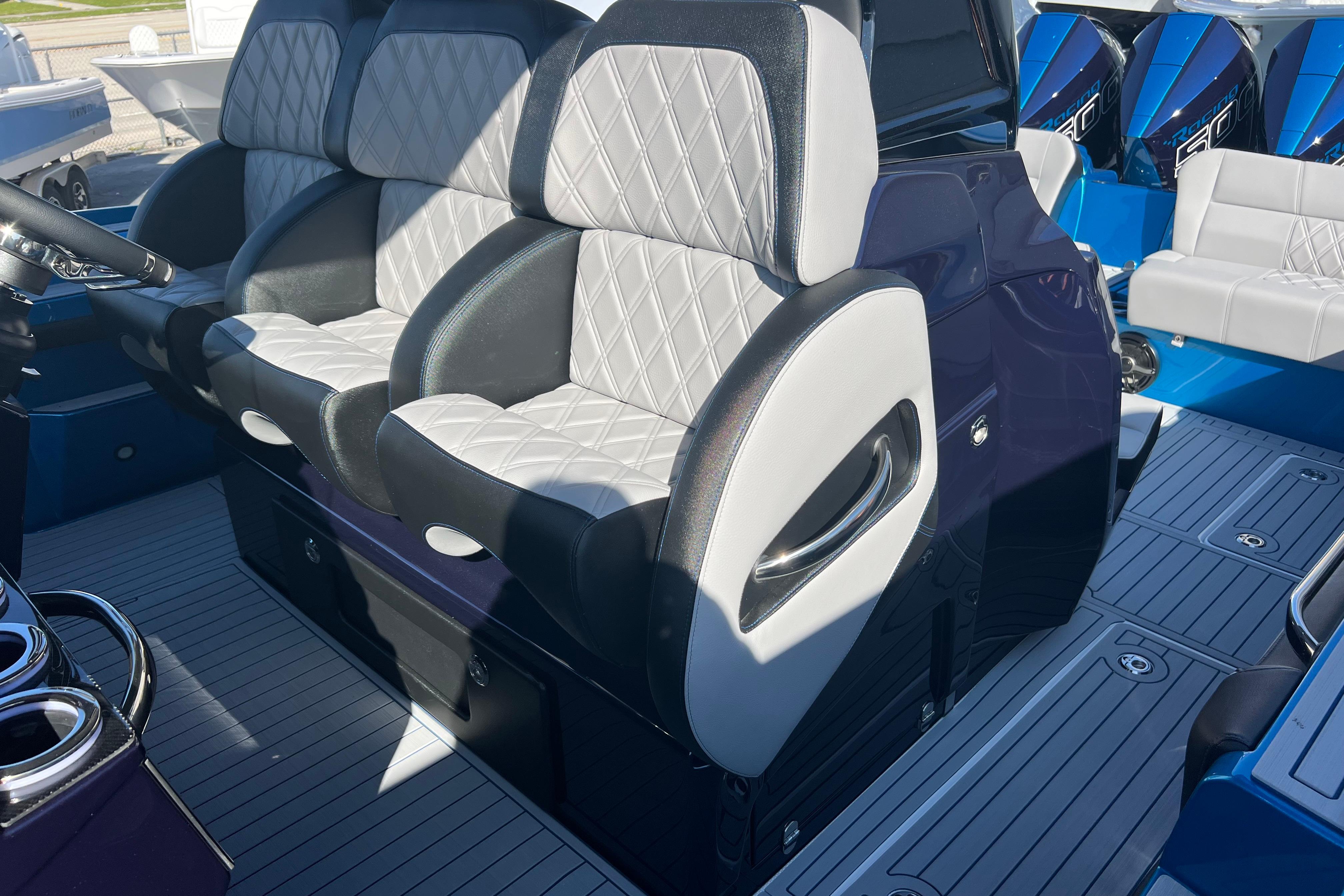 Luxury seating on 2026 Nor-Tech 450 Sport boat with quilted upholstery and sleek design.