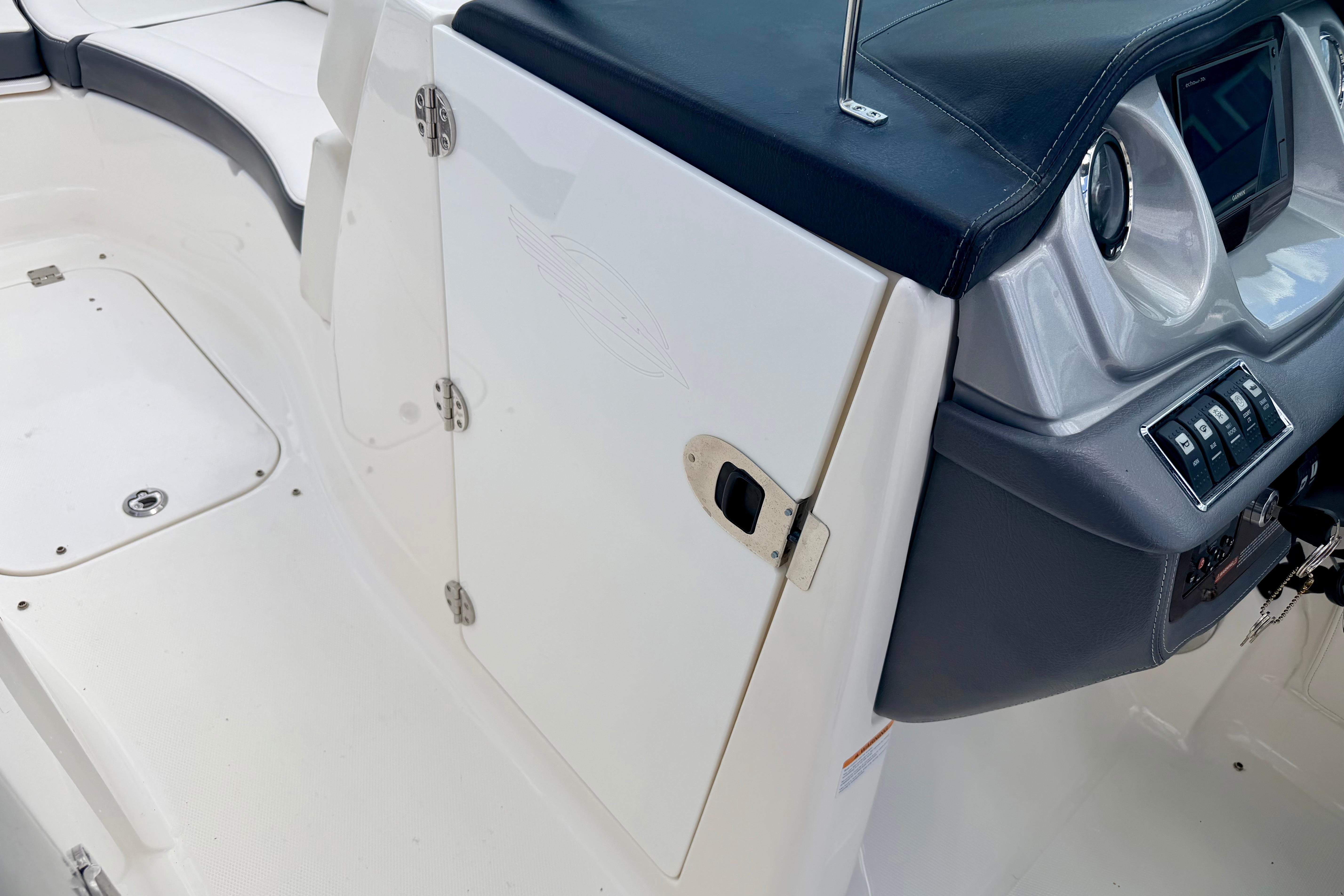 2015 Chaparral Sunesta 264 boat interior, featuring helm controls and seating area.