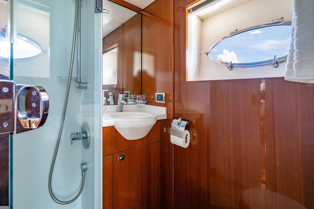 Luxurious bathroom in 2010 Princess V78 yacht with wood paneling and modern fixtures.
