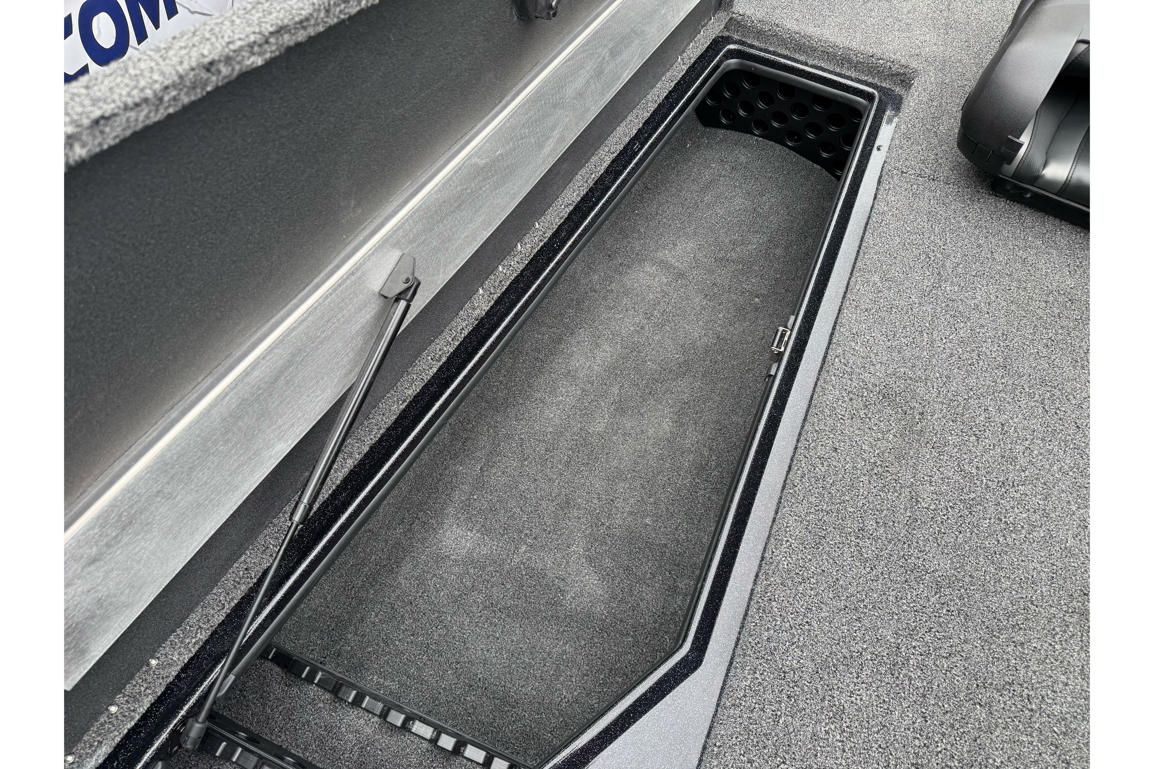 Open storage compartment in 2026 Nitro Z20 XL Pro boat, featuring carpeted interior and hydraulic lift.