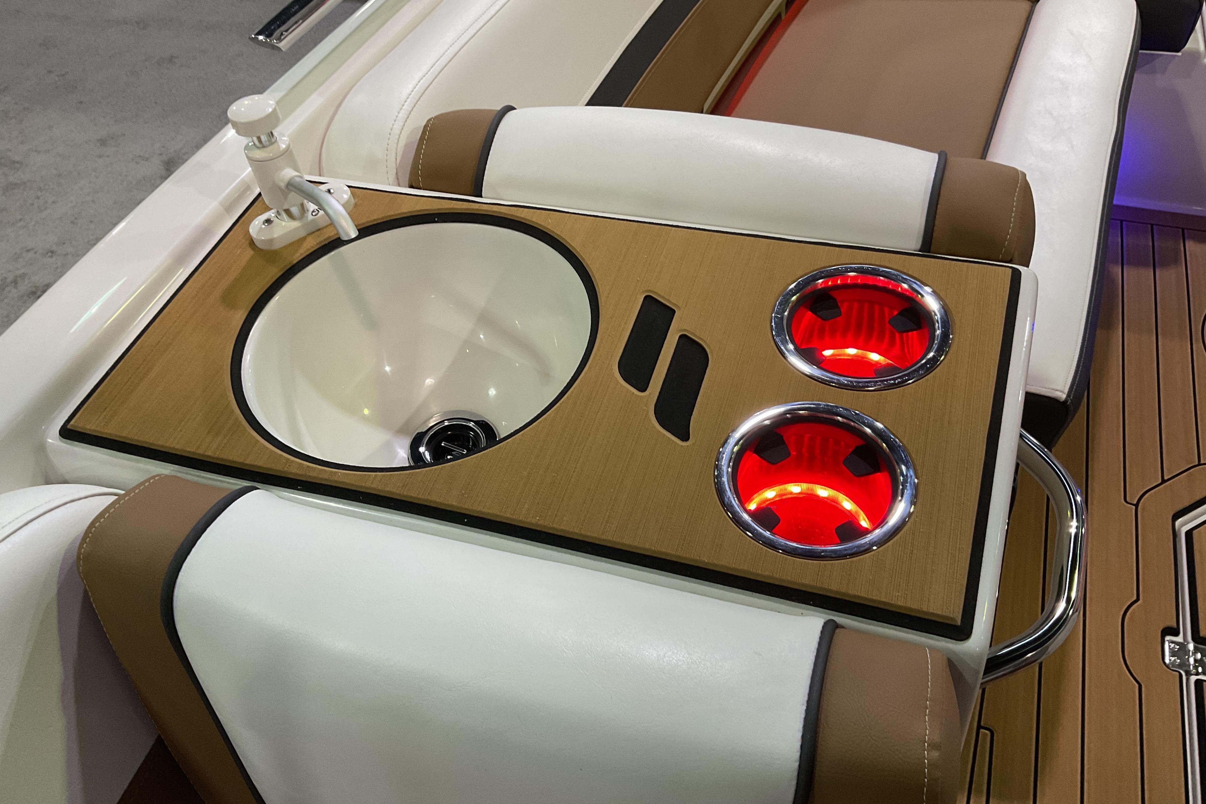 2026 Starcraft SVX 211 OB boat interior with sink and illuminated cup holders.