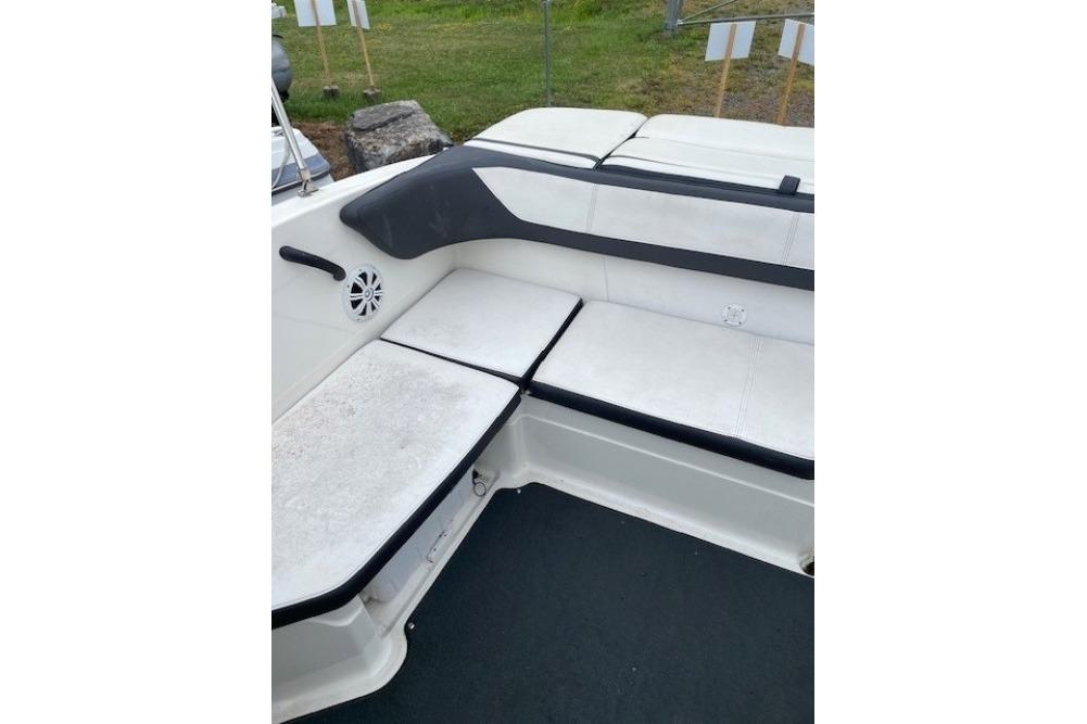 Interior seating of a 2015 Sea Ray 210 SLX boat, featuring white and black upholstery.