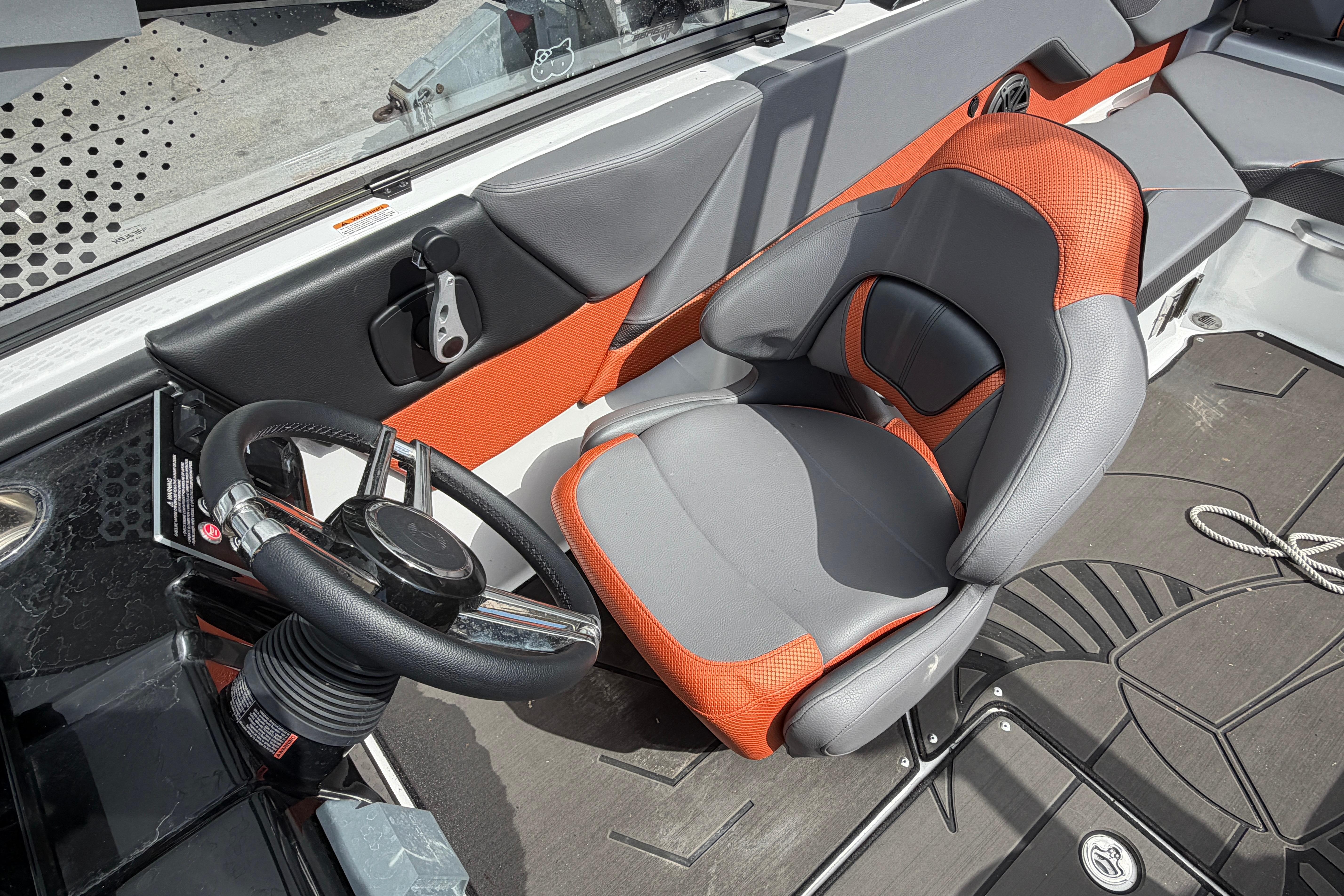 Interior of 2026 Scarab 235 LX boat with orange and gray seating.