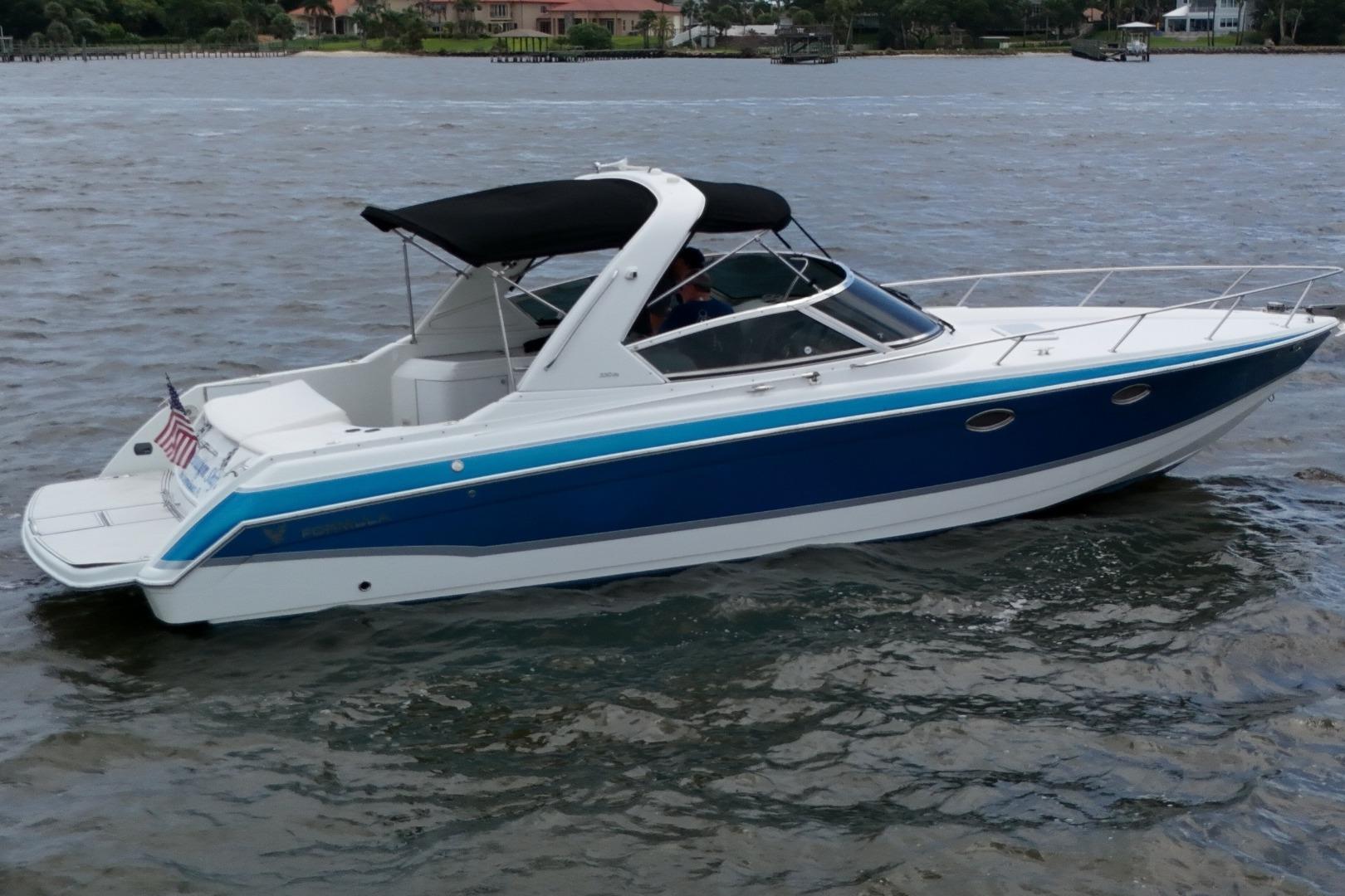 2007 Formula 330 Sun Sport boat cruising on a calm waterway.