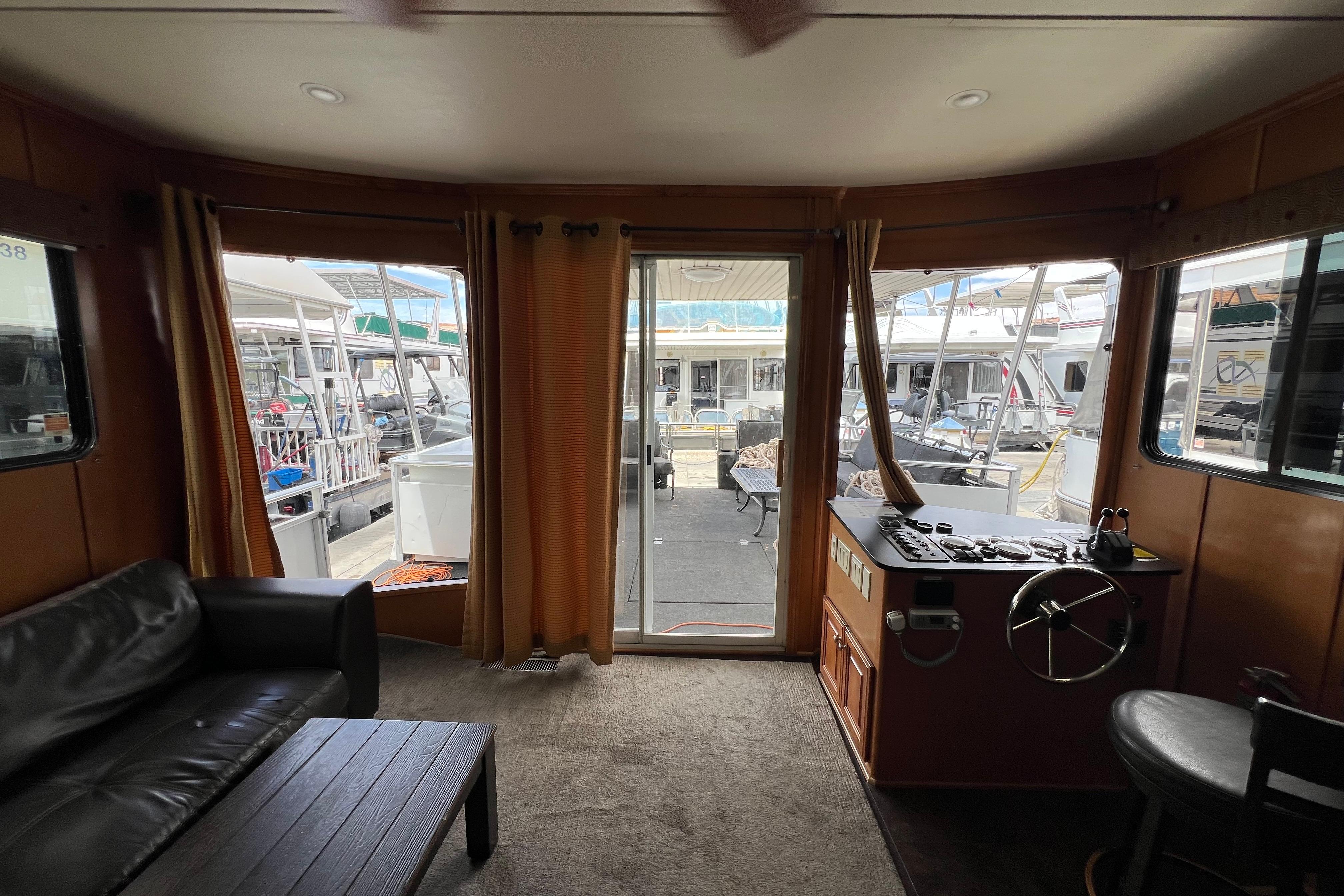 Interior of 2013 Destination Yacht Lotta Yachta with view of marina through glass doors.