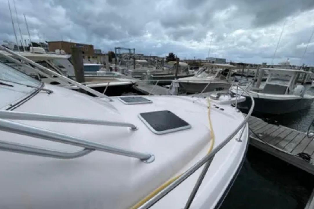 2007 Grady-White Express 330 boat docked at a marina under cloudy skies.