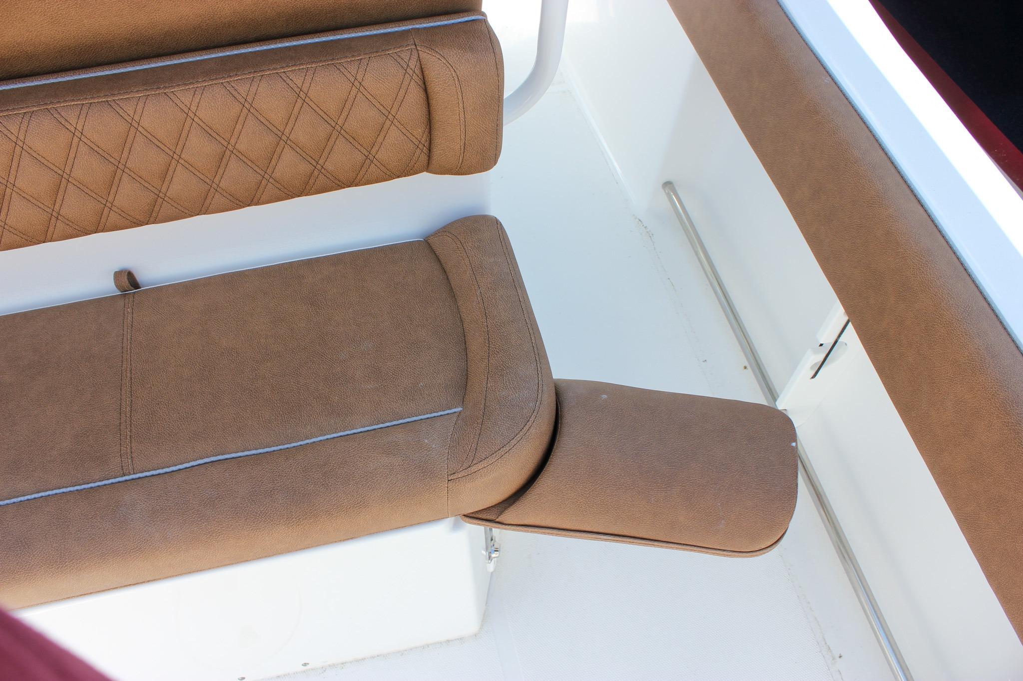 Brown cushioned seating on 2027 Sea Hunt Ultra 234 boat interior.