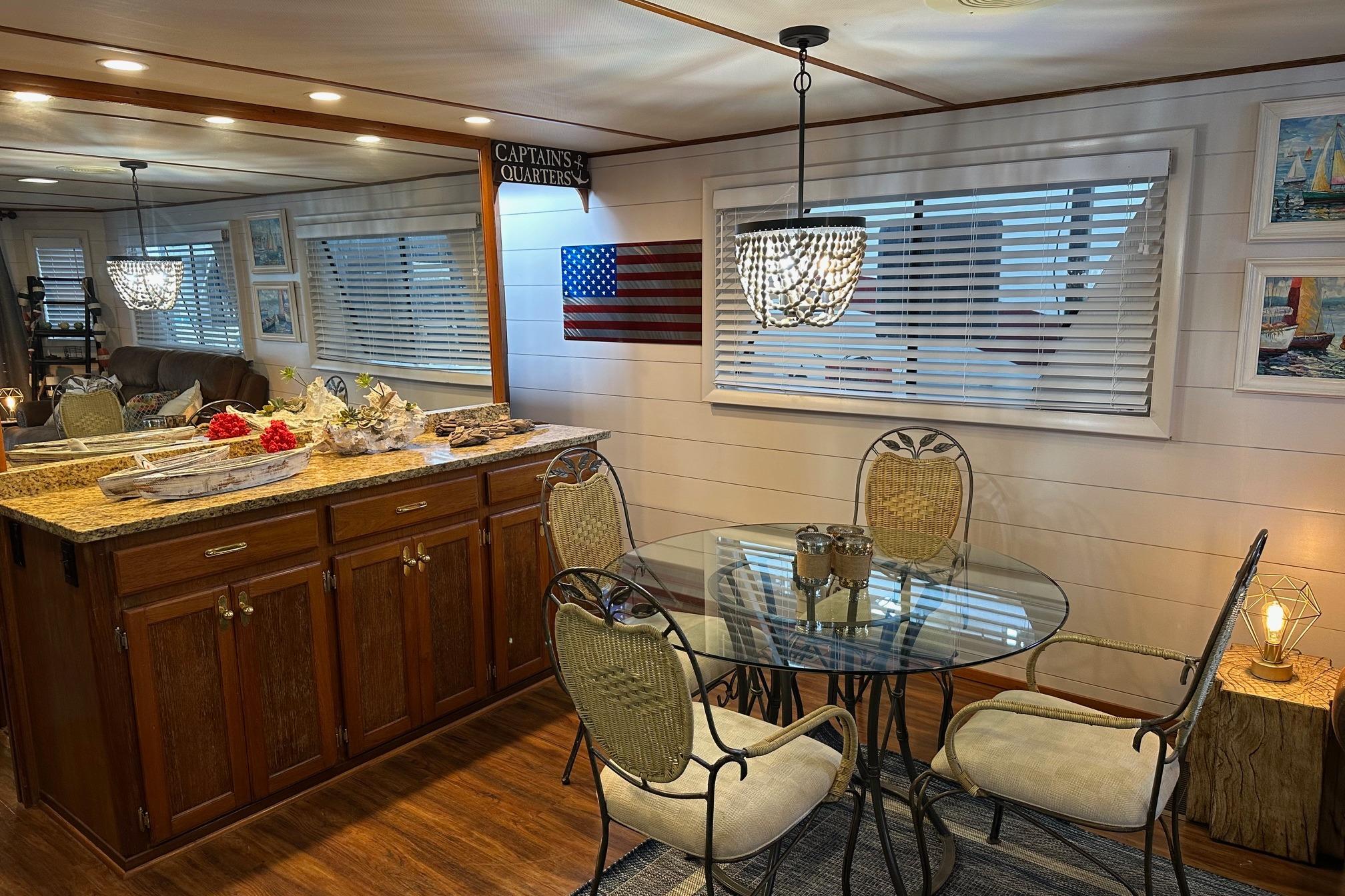 Dining area in a 1996 Lazy Days houseboat with elegant decor and wooden cabinetry.
