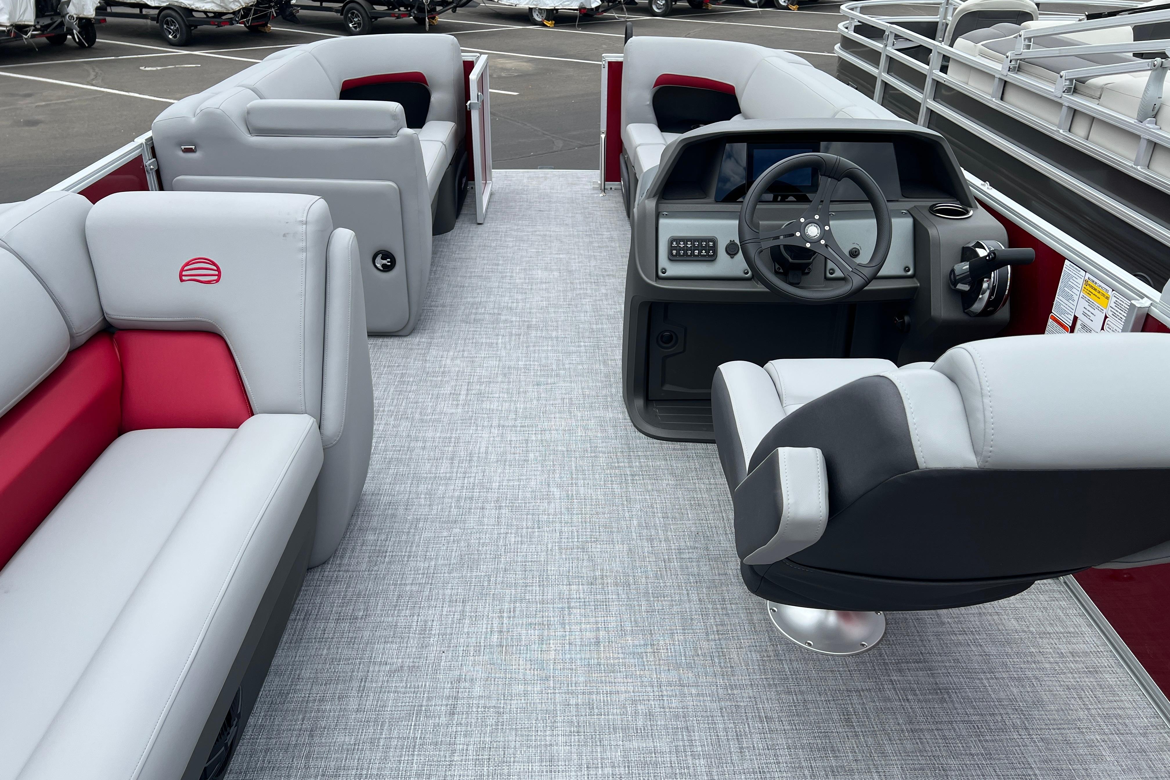 2026 Sun Tracker Party Barge 20 DLX interior with plush seating and modern helm.