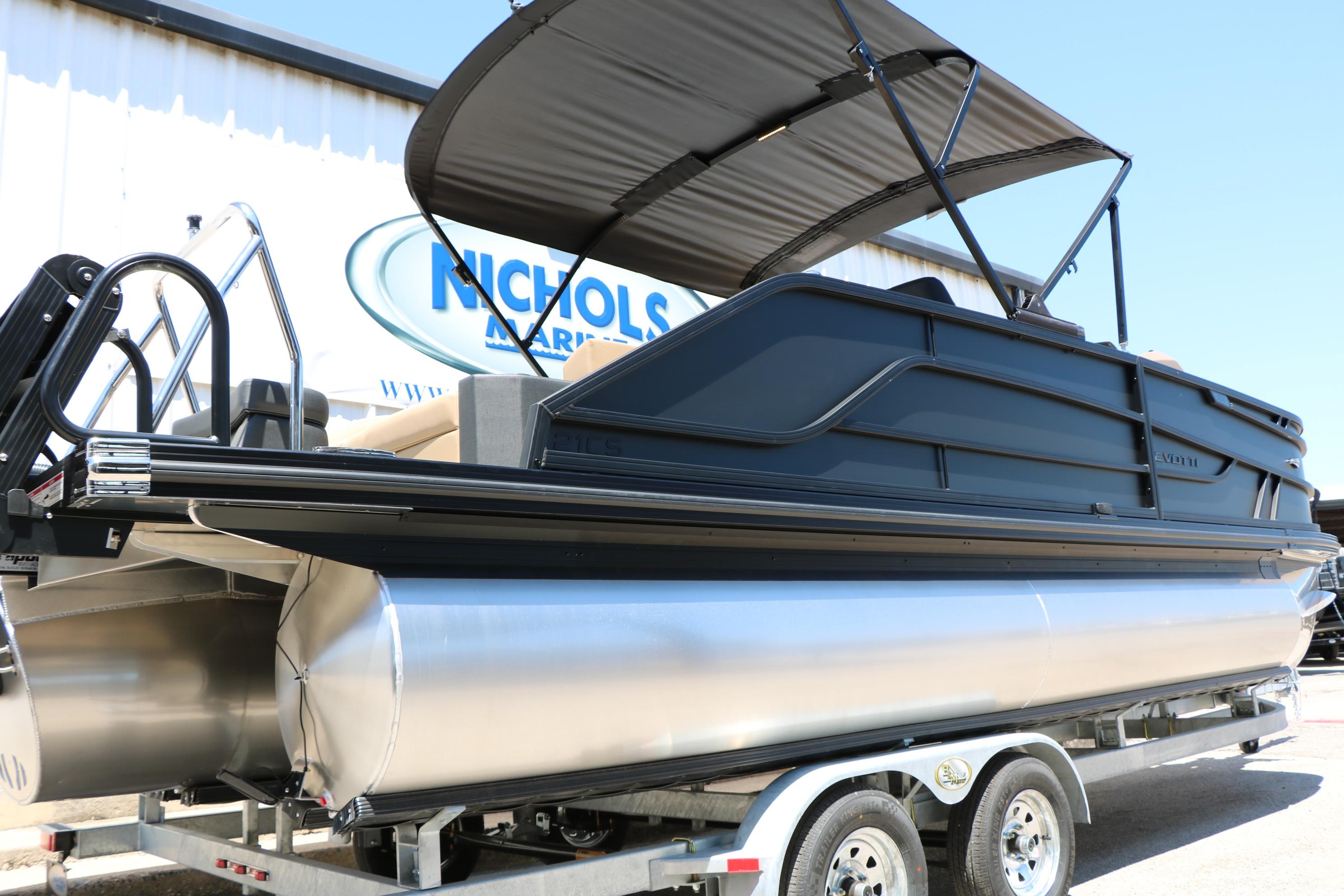 2026 Evotti 521CS pontoon boat on trailer, featuring sleek design and canopy.