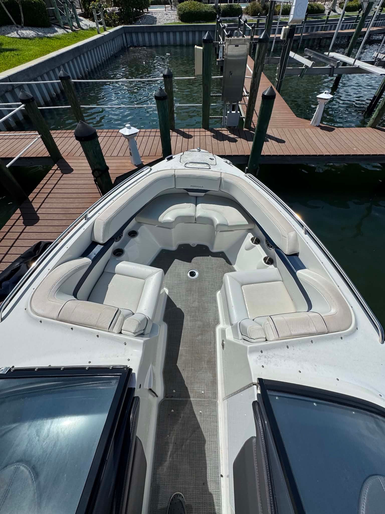 2018 Formula 270 Bowrider boat at dock with spacious seating area.
