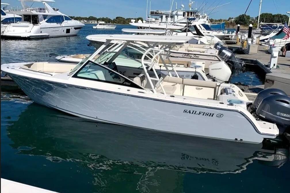 2022 Sailfish 276 DC boat docked in marina, featuring sleek design and Yamaha engines.