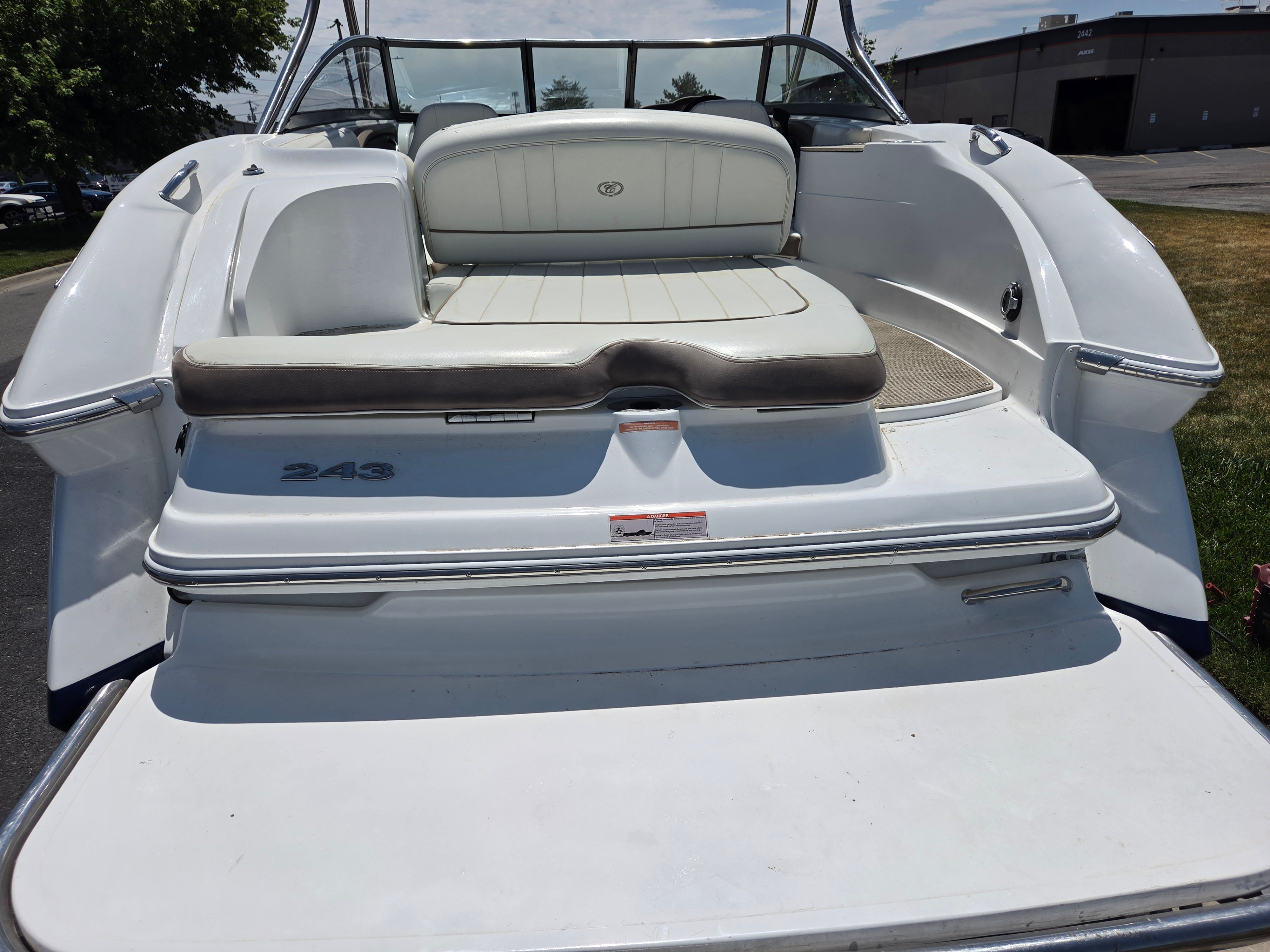 The image shows the rear of a Cobalt 243 boat with white seating.