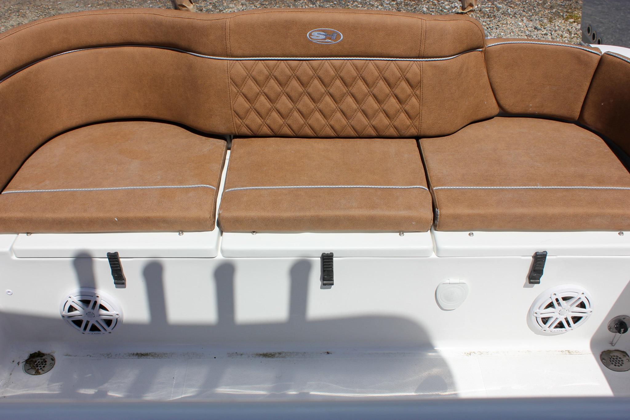 Brown cushioned seating on 2027 Sea Hunt Ultra 234 boat, featuring diamond stitching and white base.