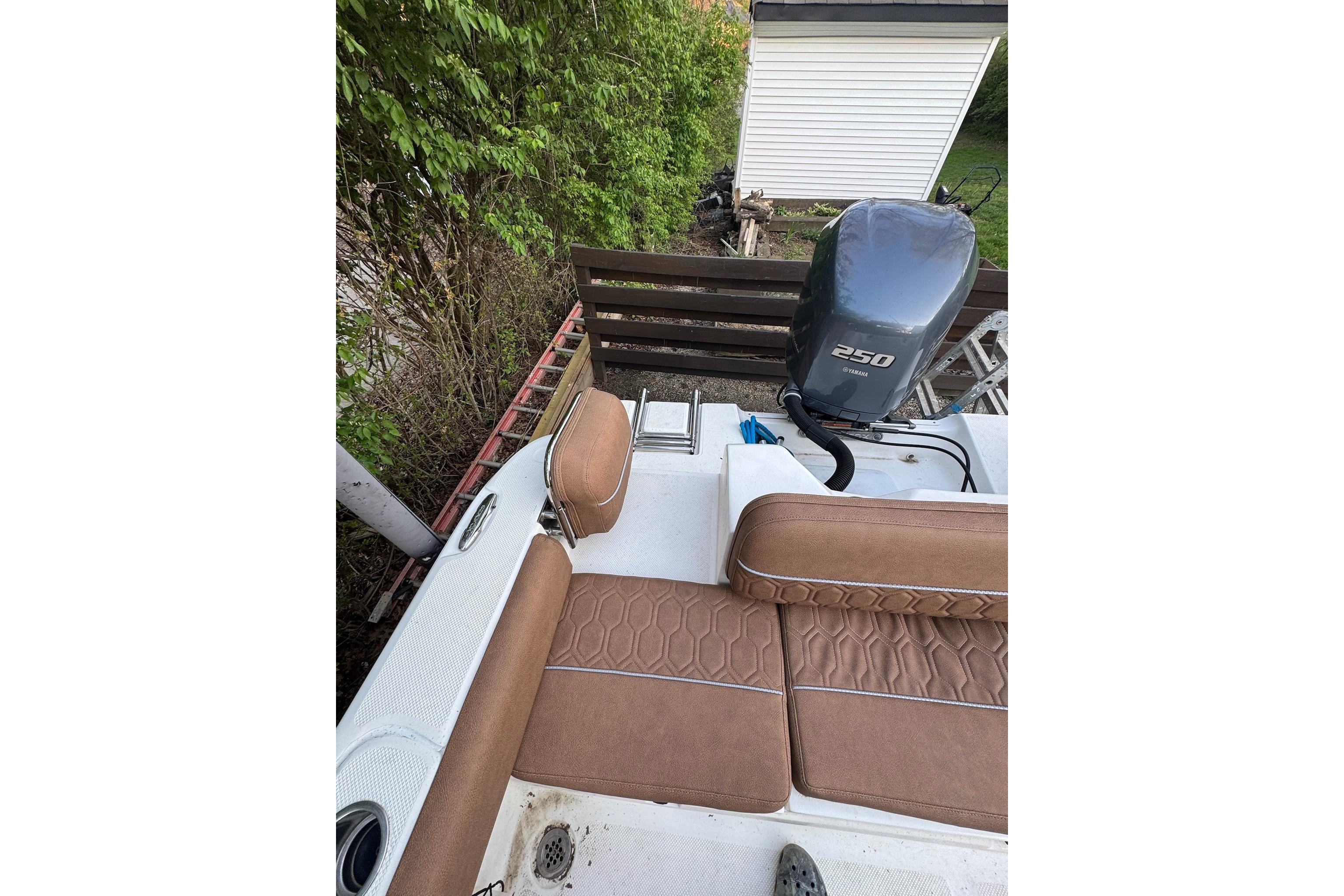2013 Sea Fox 246 Commander boat with Yamaha 250 engine, featuring brown seating and outdoor setting.