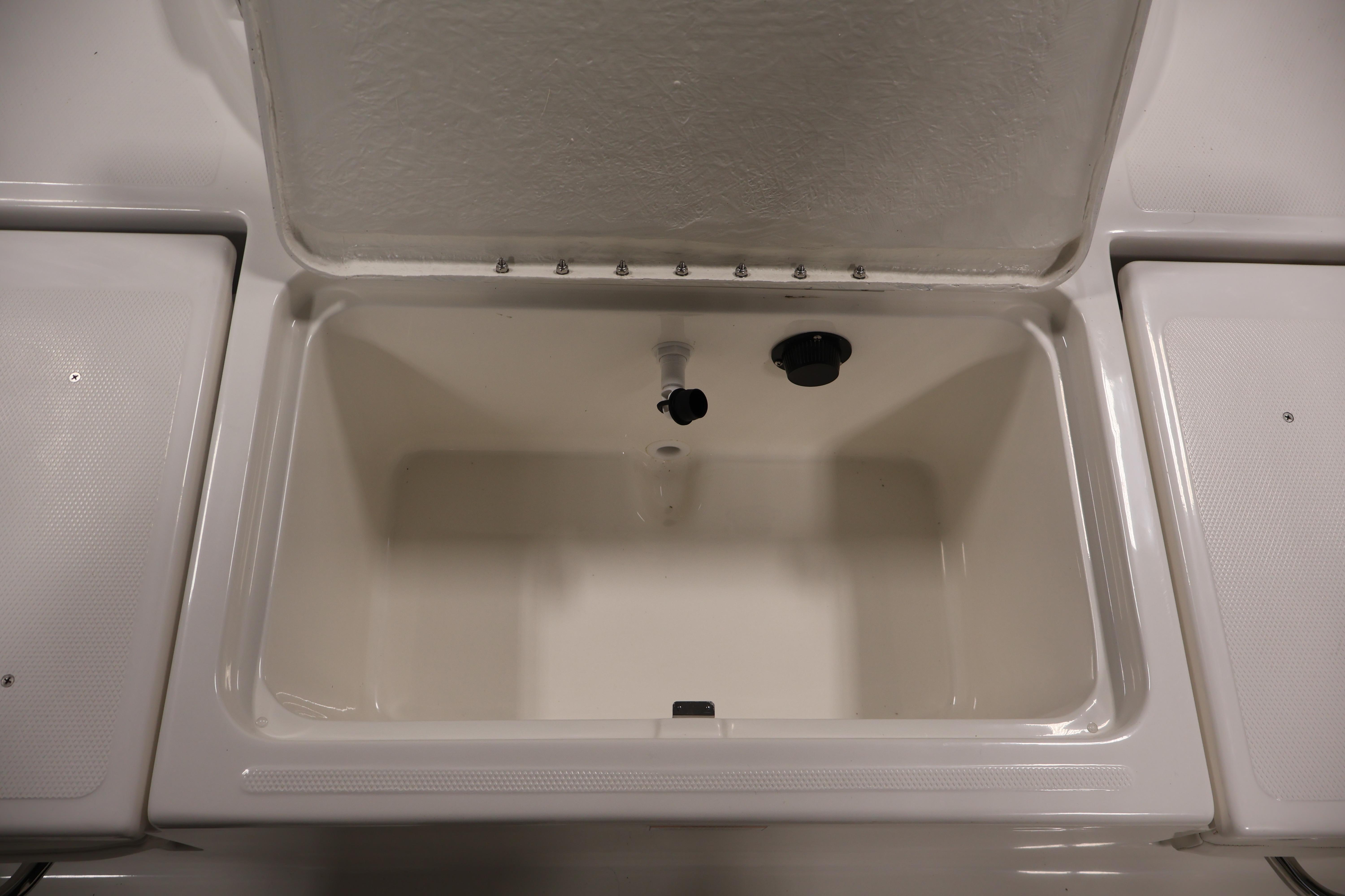 Open storage compartment on 2026 Bayliner Trophy T18 boat, showcasing interior space.