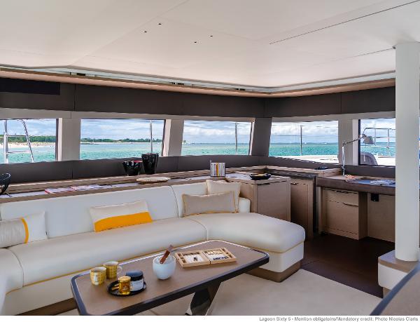 Luxurious interior of 2025 Lagoon SIXTY 5 yacht with ocean view and modern furnishings.