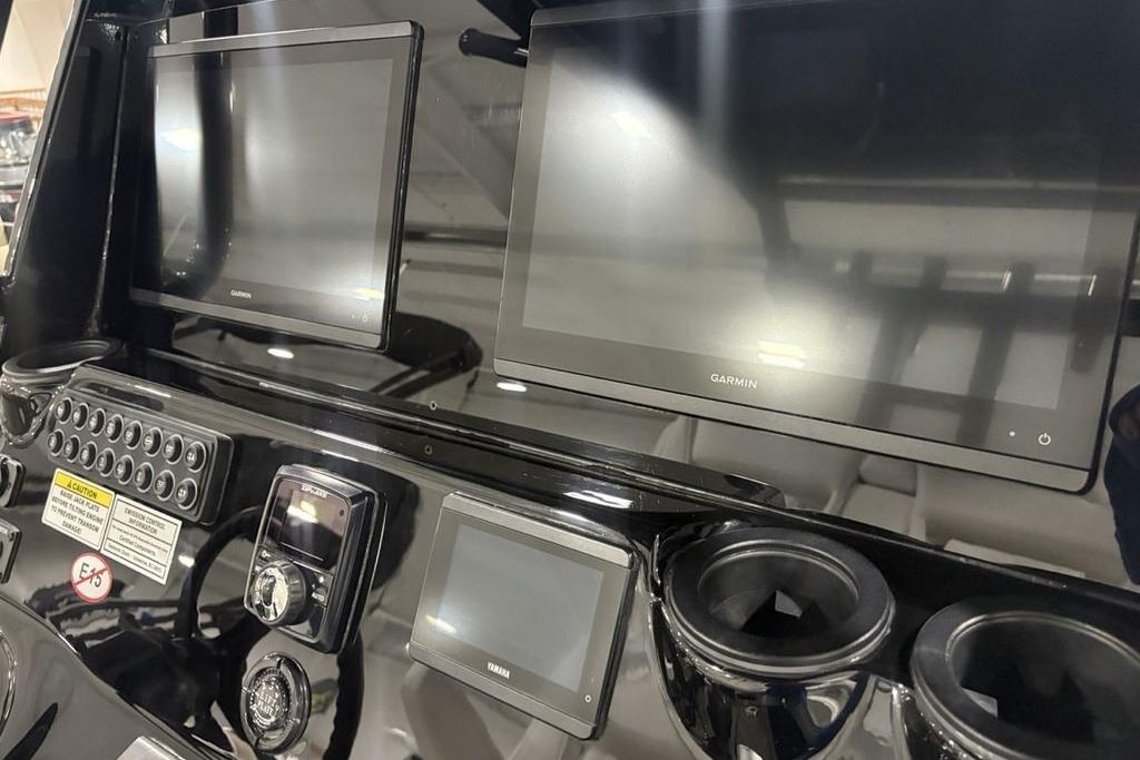 2026 Tidewater 3100 Carolina Bay dashboard with Garmin displays and control panel.