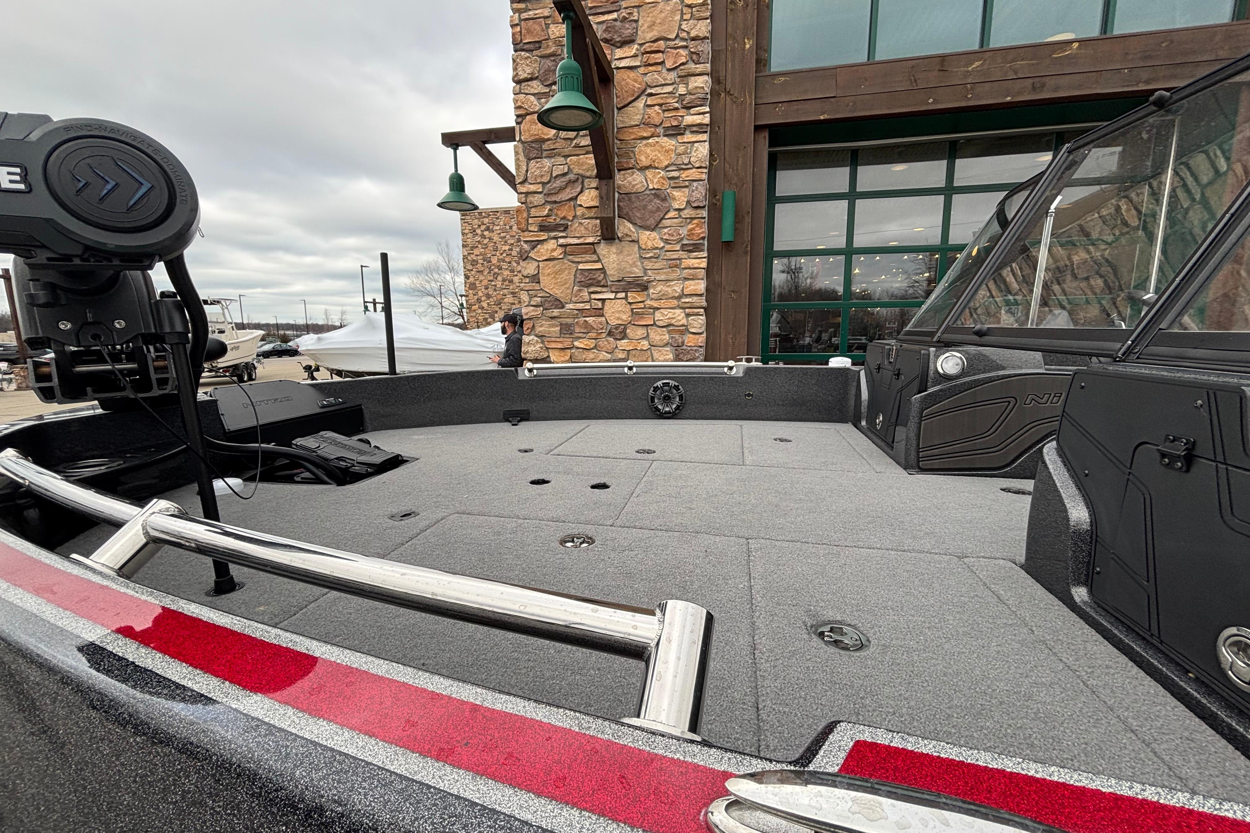 2024 Nitro ZV21 Pro boat deck with modern design and equipment, parked near a stone building.