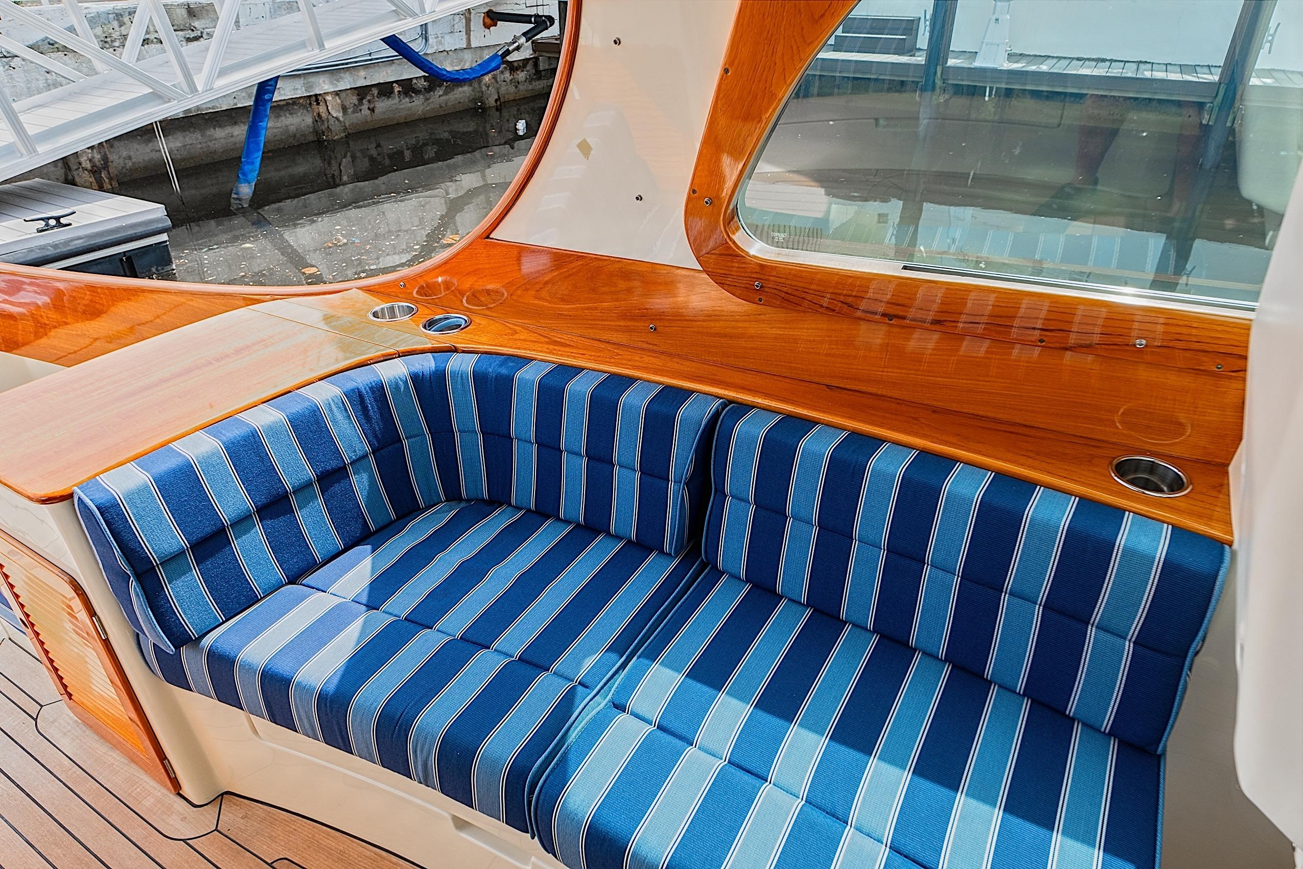 Luxurious interior of 2018 Hinckley Picnic Boat 37 MKIII with striped seating and polished wood finish.