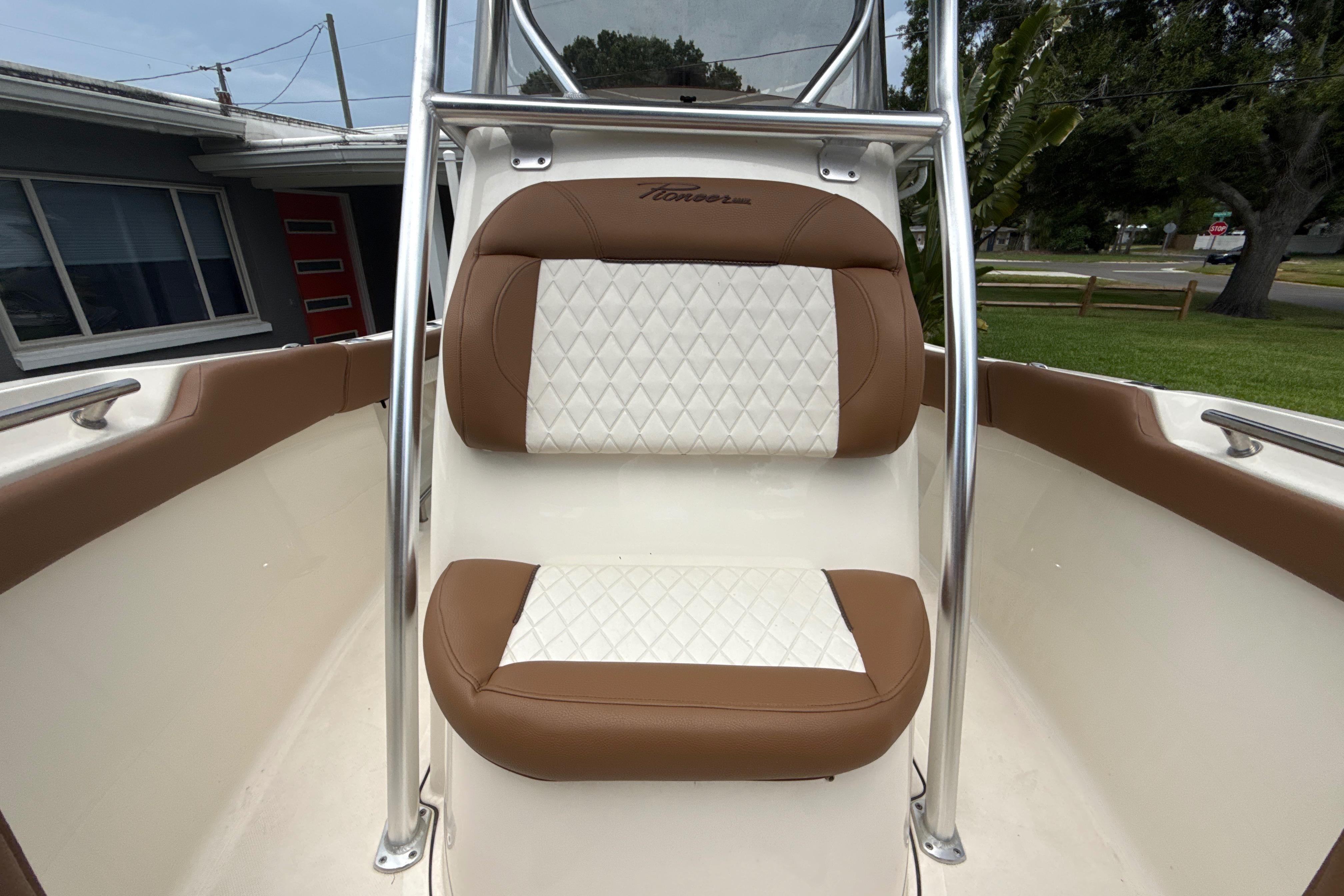 2023 Pioneer 202 Islander boat seat with brown and white diamond-pattern upholstery.