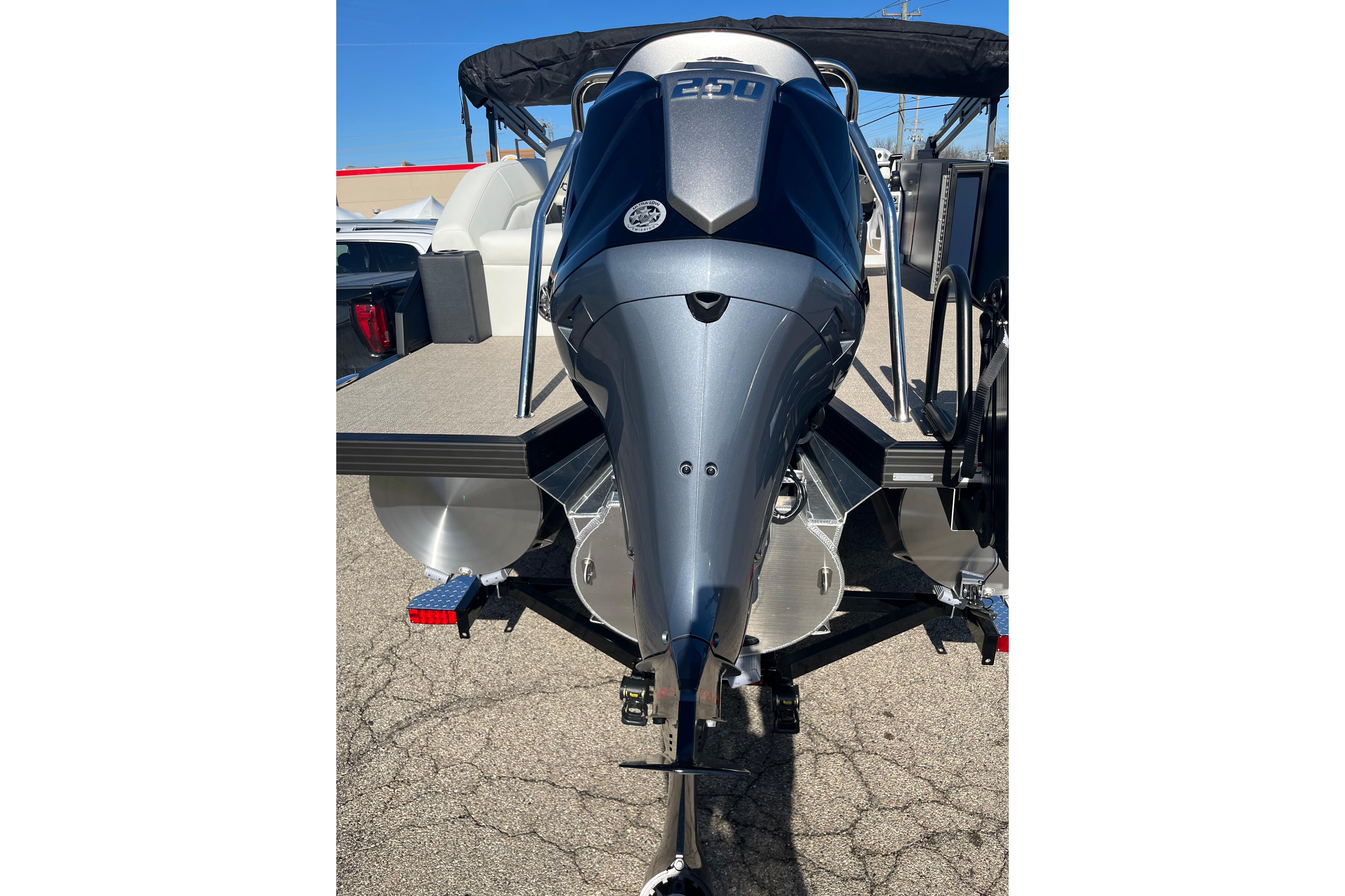 2026 Evotti 523CS boat with powerful outboard motor, parked on pavement.
