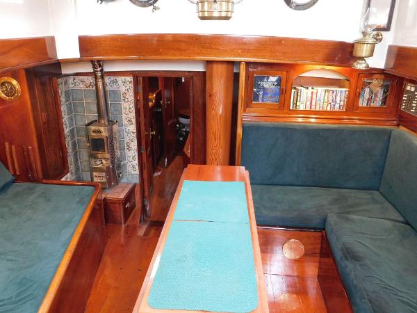 Interior of 1983 Custom Murray Peterson Coaster III with wood paneling and cozy seating.
