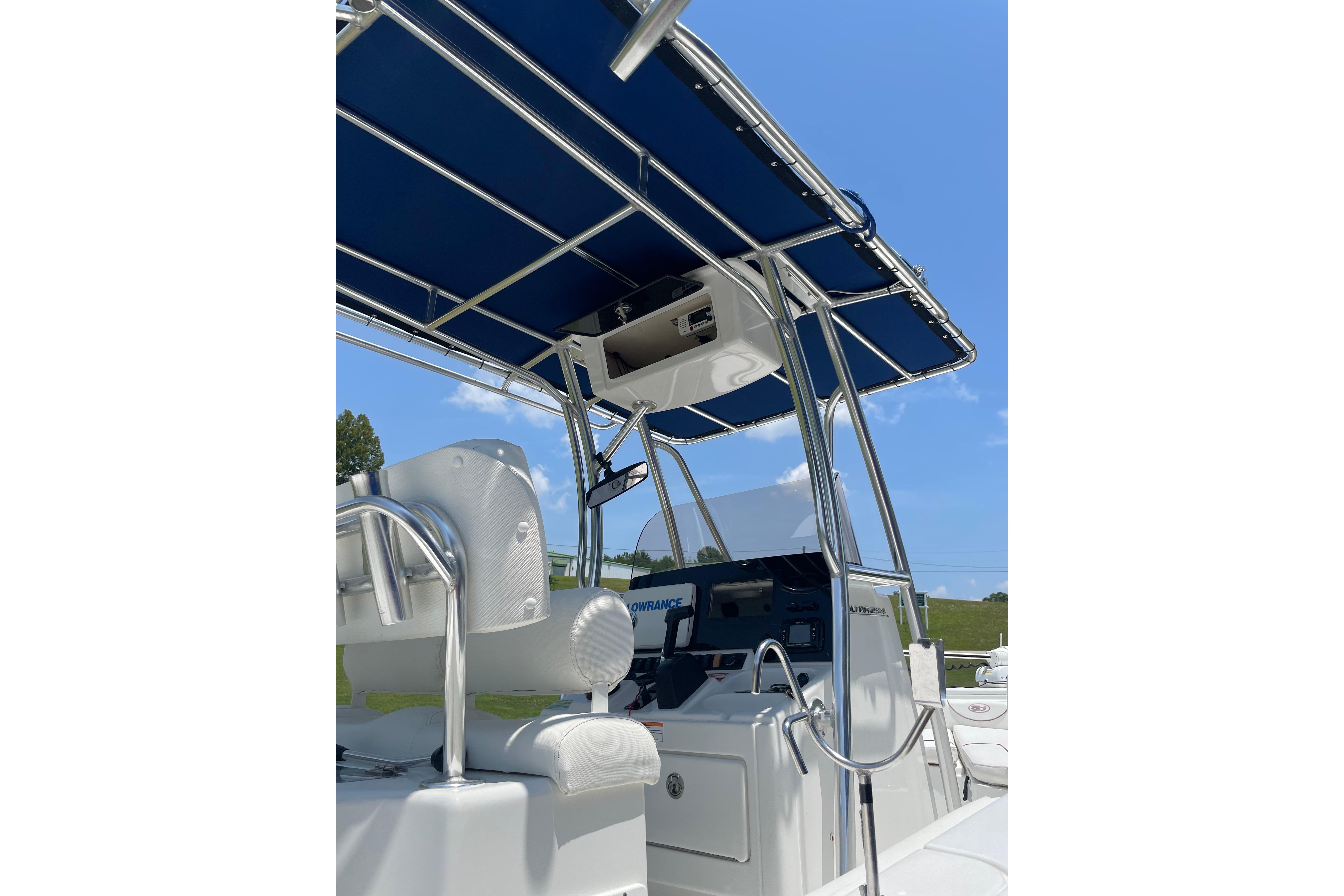 2018 Sea Hunt Ultra 234 boat with blue canopy and sleek console design.