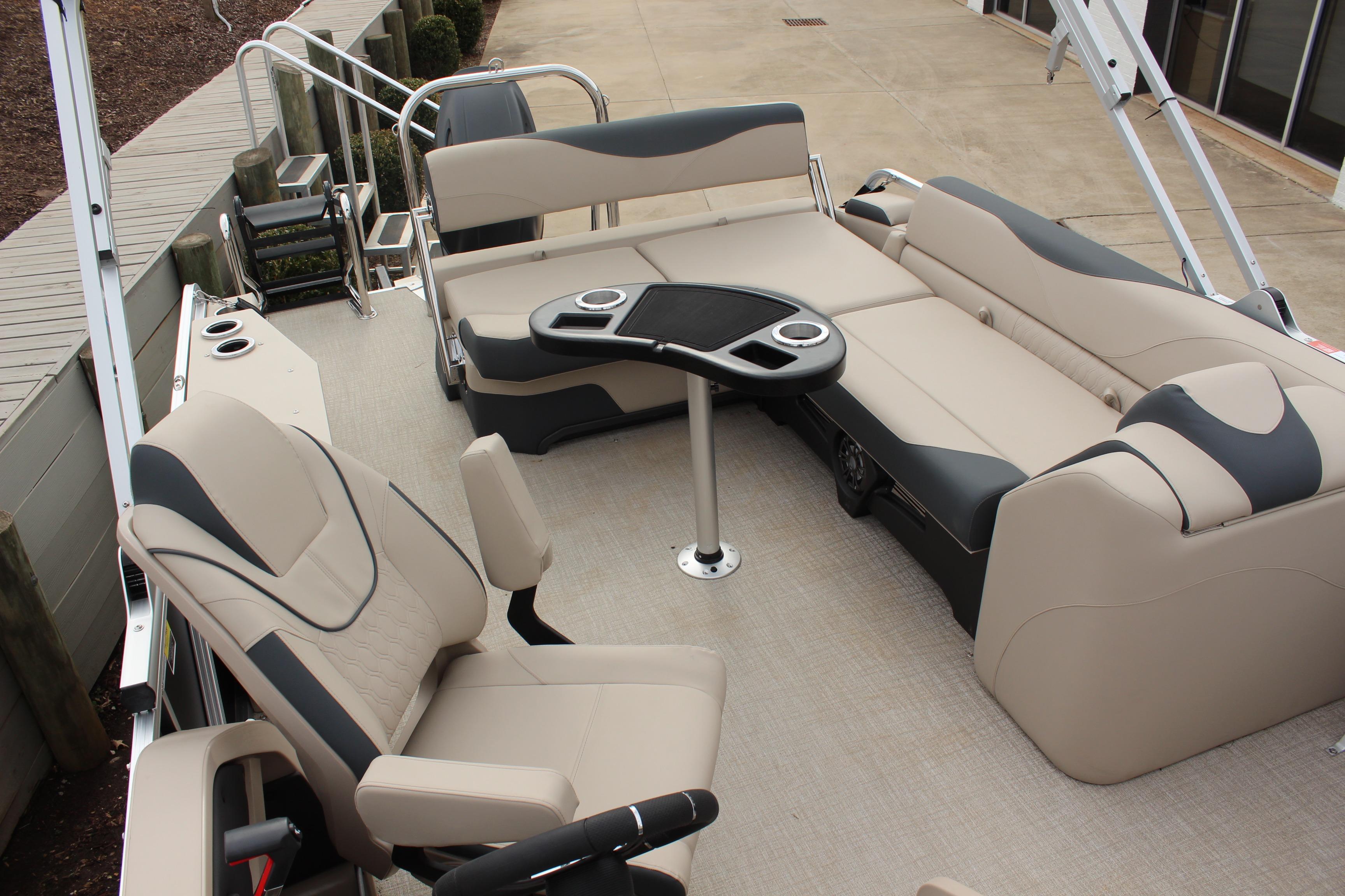2026 Tahoe Pontoon LTZ interior with beige seating and table, docked at marina.