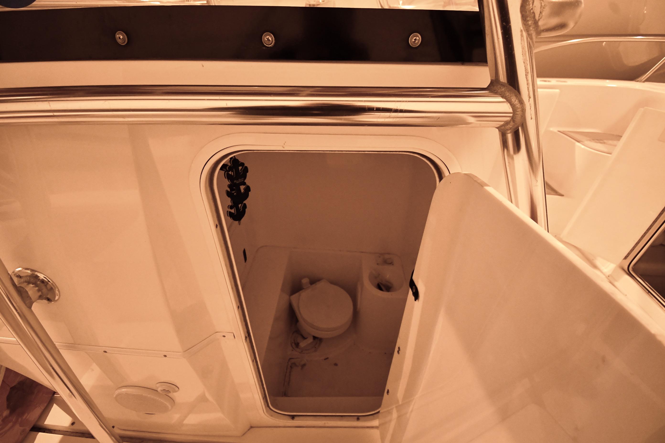 2001 Fountain 38 Center Console boat interior with open storage compartment.