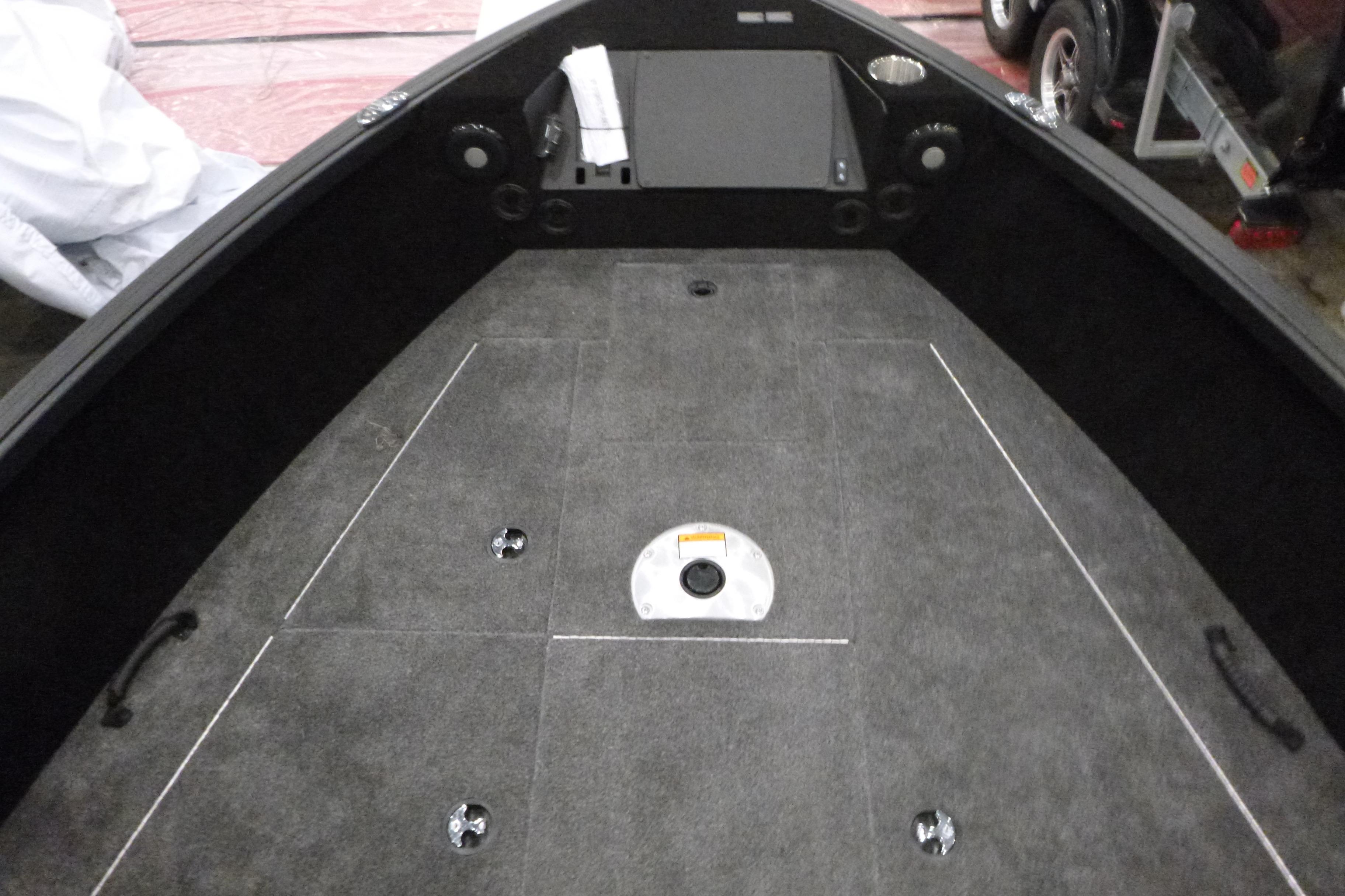 2025 Alumacraft Trophy 185X Sport boat interior with carpeted deck and storage compartments.