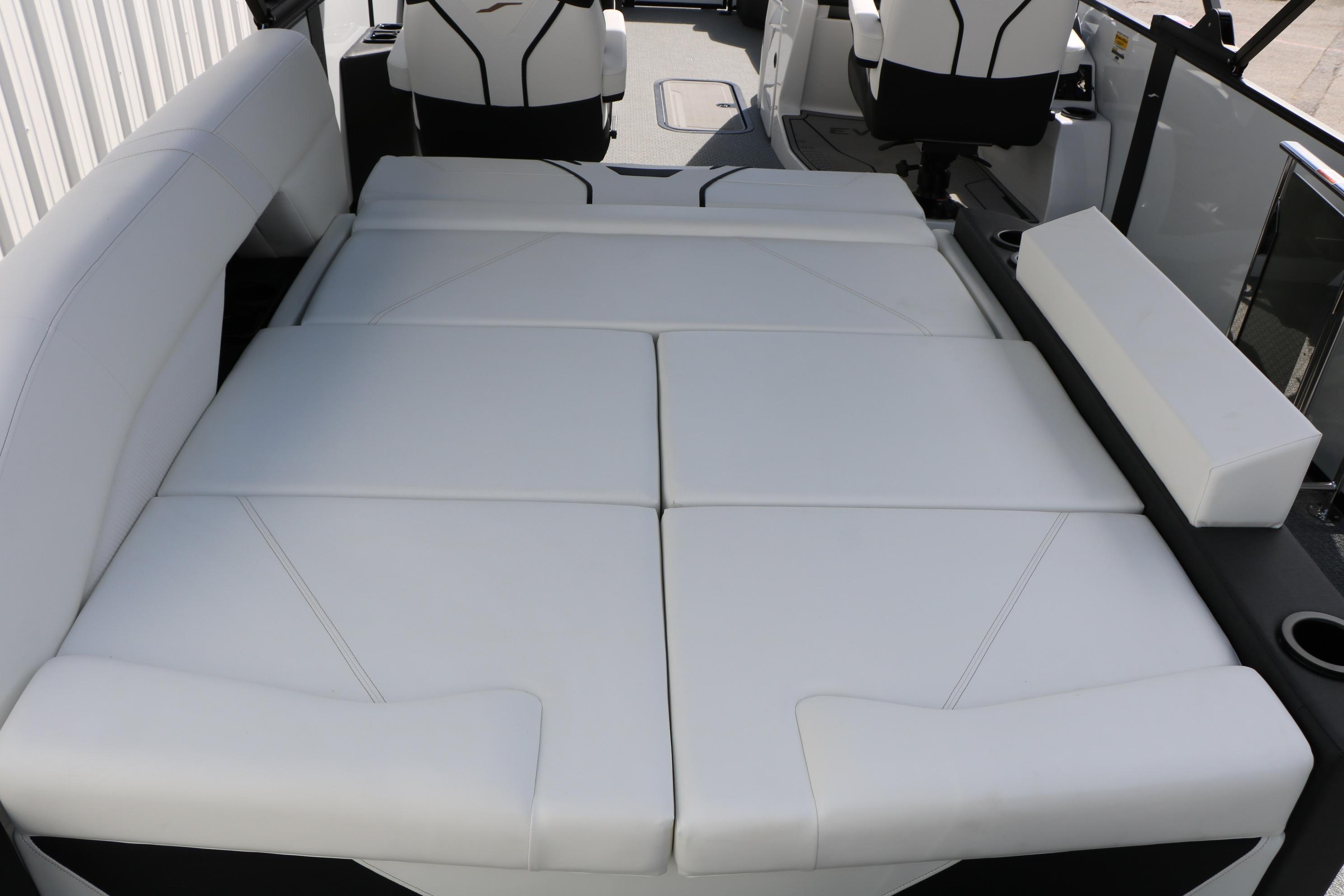 Luxurious white seating on 2026 Evotti 725 CS Tri-Toon boat interior.
