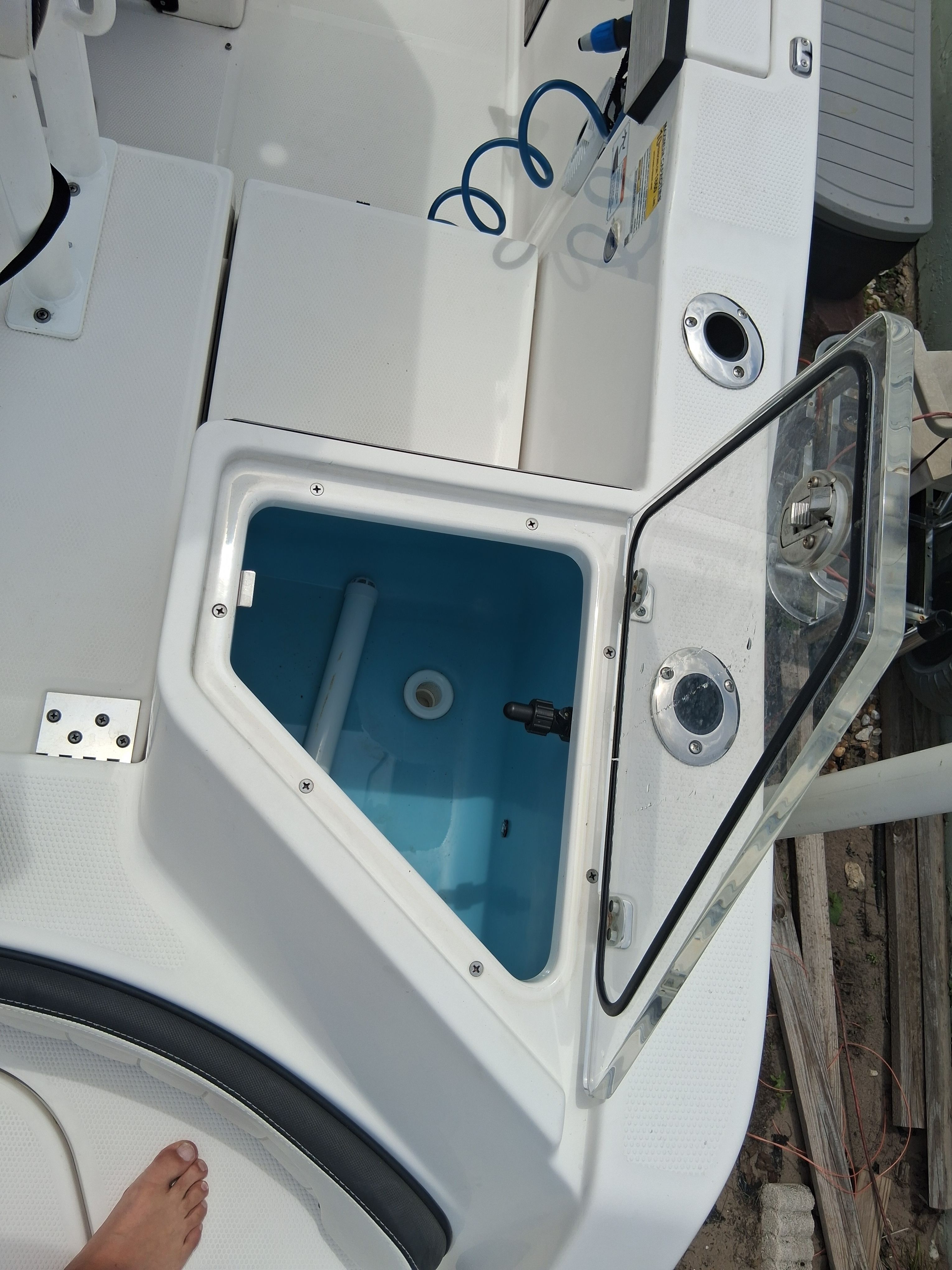 Yamaha Boats 220 FSH Sport 2023 with an open storage compartment and blue interior lining.
