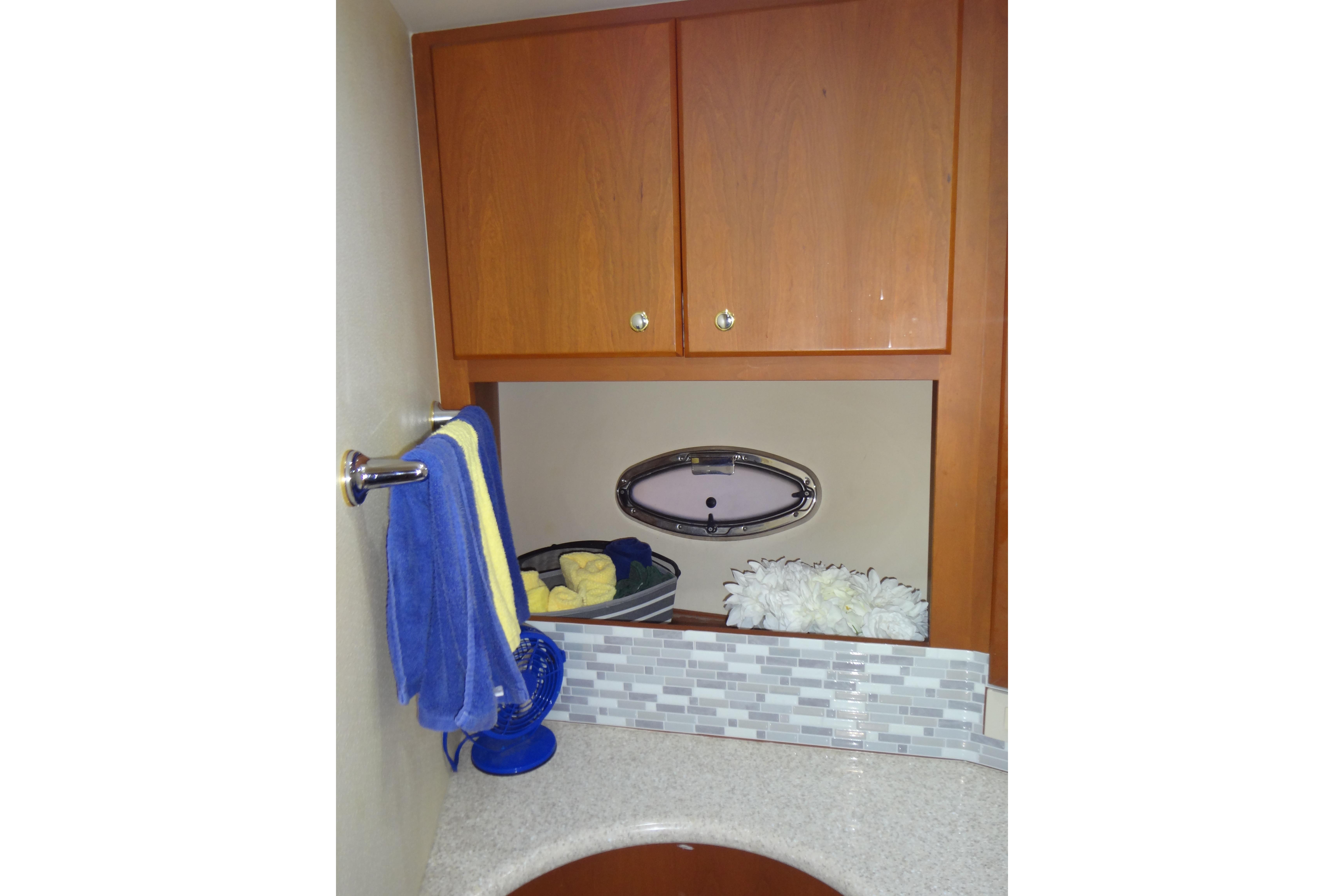 2005 Silverton 34 Convertible bathroom with wooden cabinets and decorative accents.