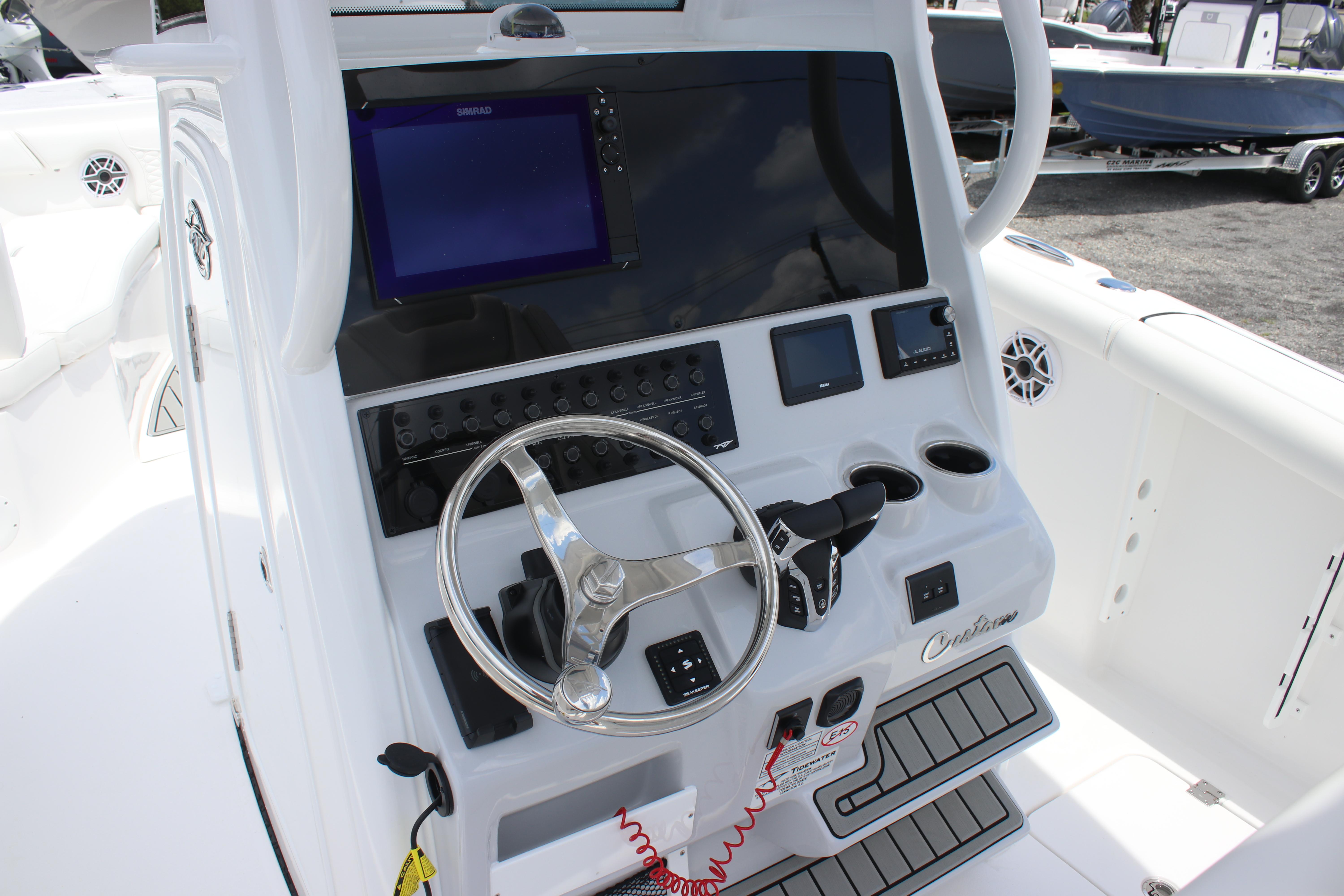 2026 Tidewater 272 LXF boat dashboard with steering wheel and navigation controls.