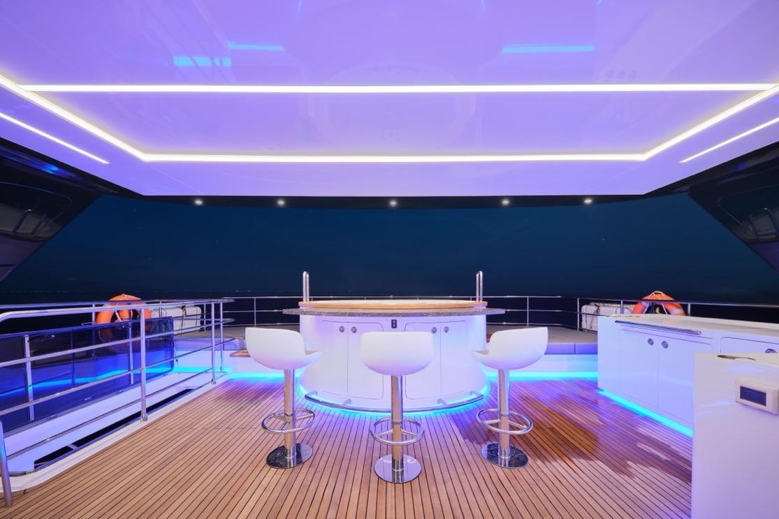 Luxurious Heysea Seaview 75 yacht deck with modern bar and ambient lighting, 2026 model.