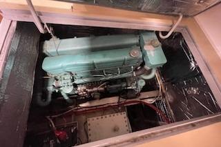 1964 Striker Model 120 engine in a compartment, showcasing vintage machinery.