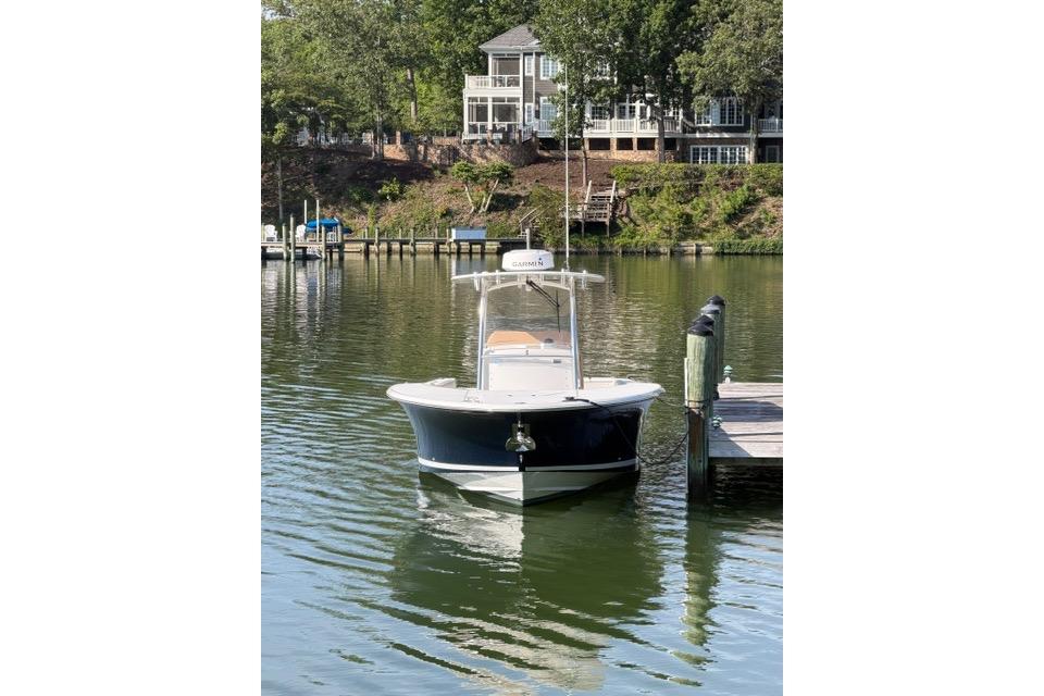 2014 Southport 29 FE boat docked on calm water near residential area.