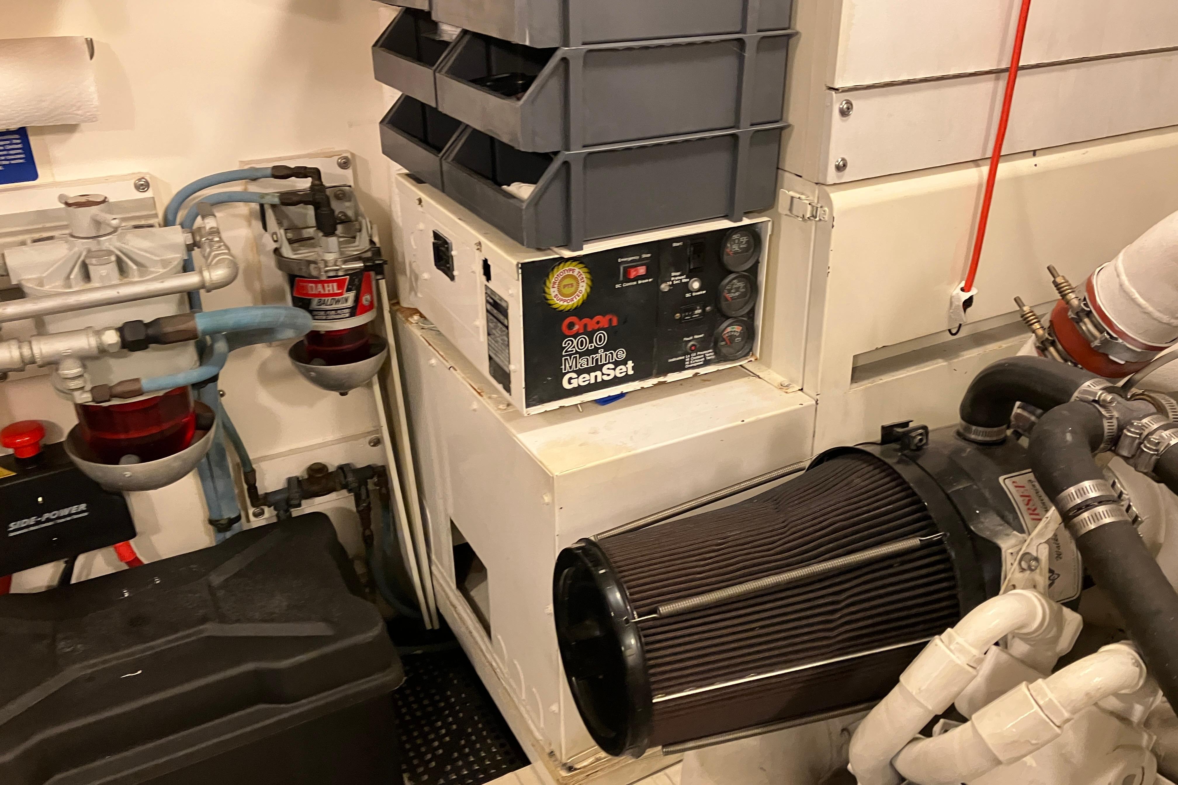 Engine room of 1995 Viking 50 Motor Yacht with Onan marine generator and filtration system.