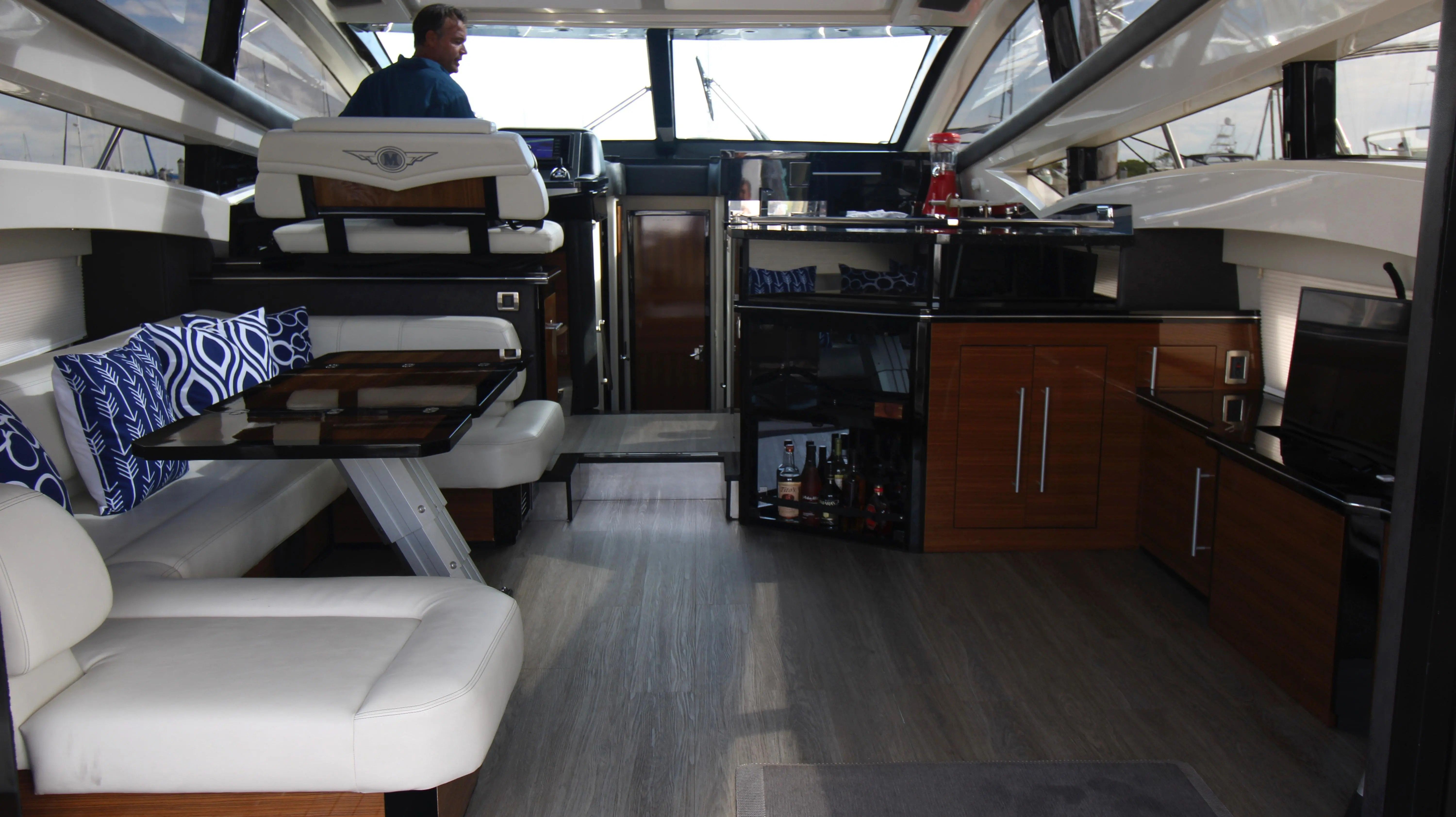 Interior of a 2010 Marquis Sport Coupe with sleek seating and modern kitchen.