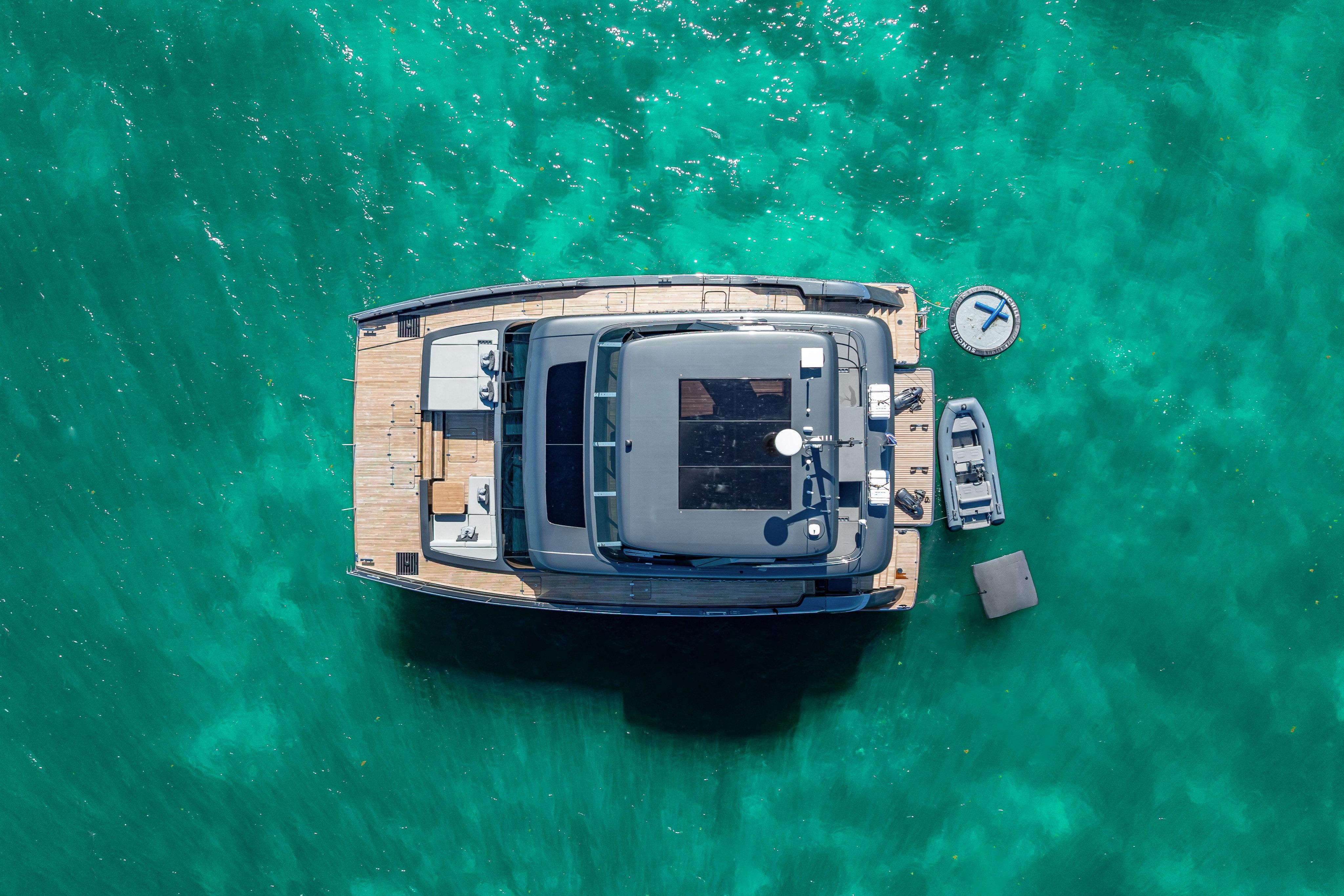 Aerial view of 2026 Sunreef 60 Power yacht on turquoise water.