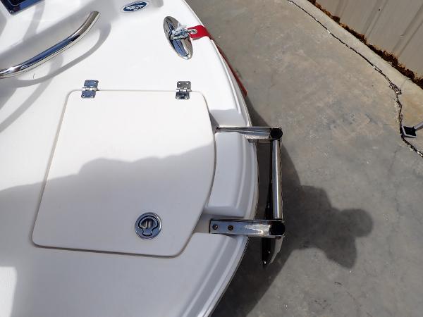 2011 Chaparral 287 SSX boat with swim platform and ladder on concrete surface.