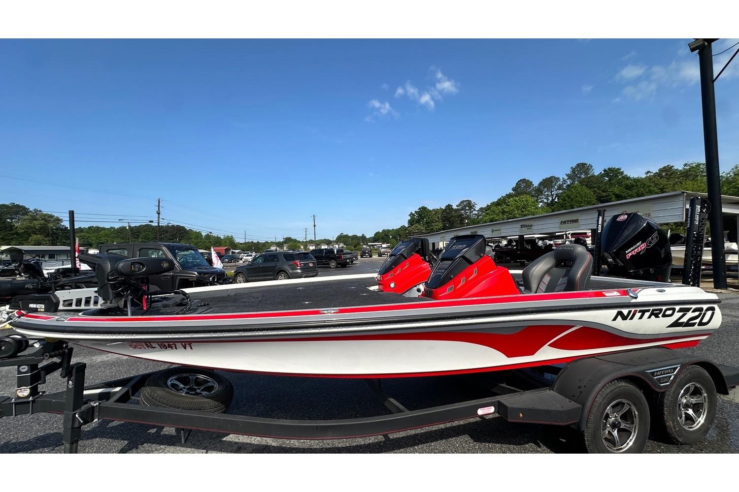 2023 Nitro Z20 Pro boat in parking lot, featuring sleek design and vibrant red accents.