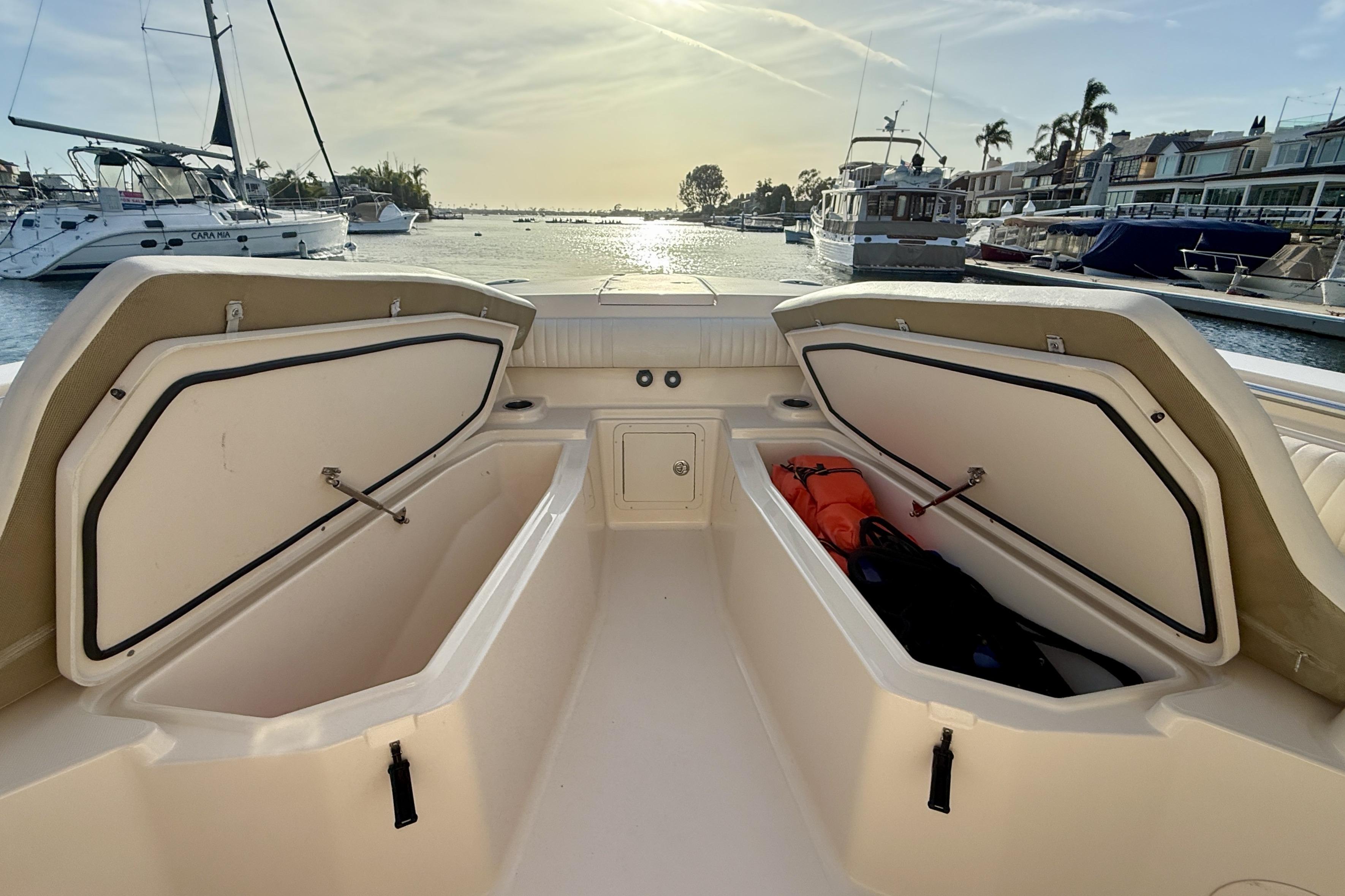 2012 Grady-White Canyon 336 boat with open storage compartments, docked in a marina.