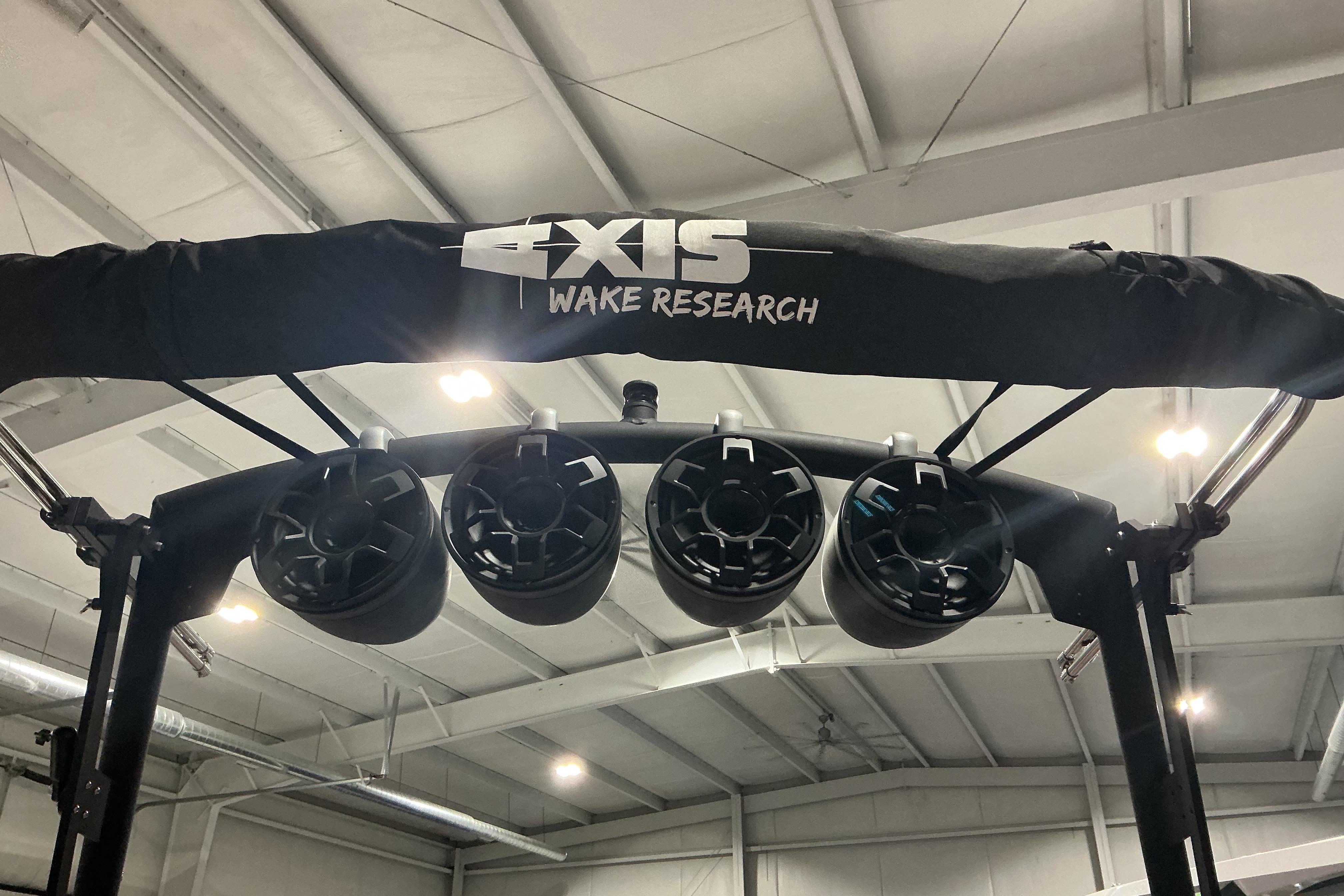 2022 Axis T250 wakeboard tower with speakers in a showroom.