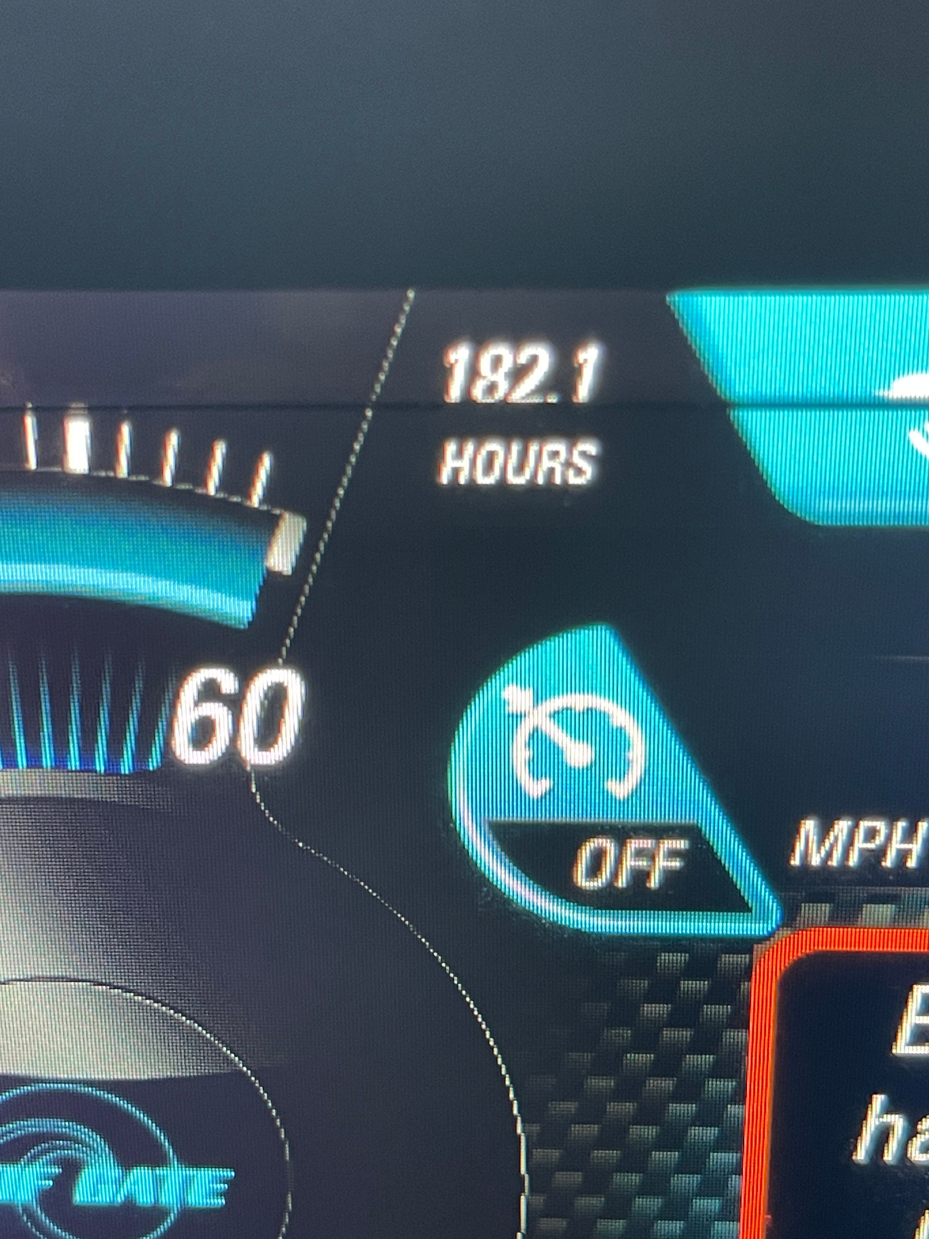 Close-up of a boat dashboard showing 182.1 operating hours.