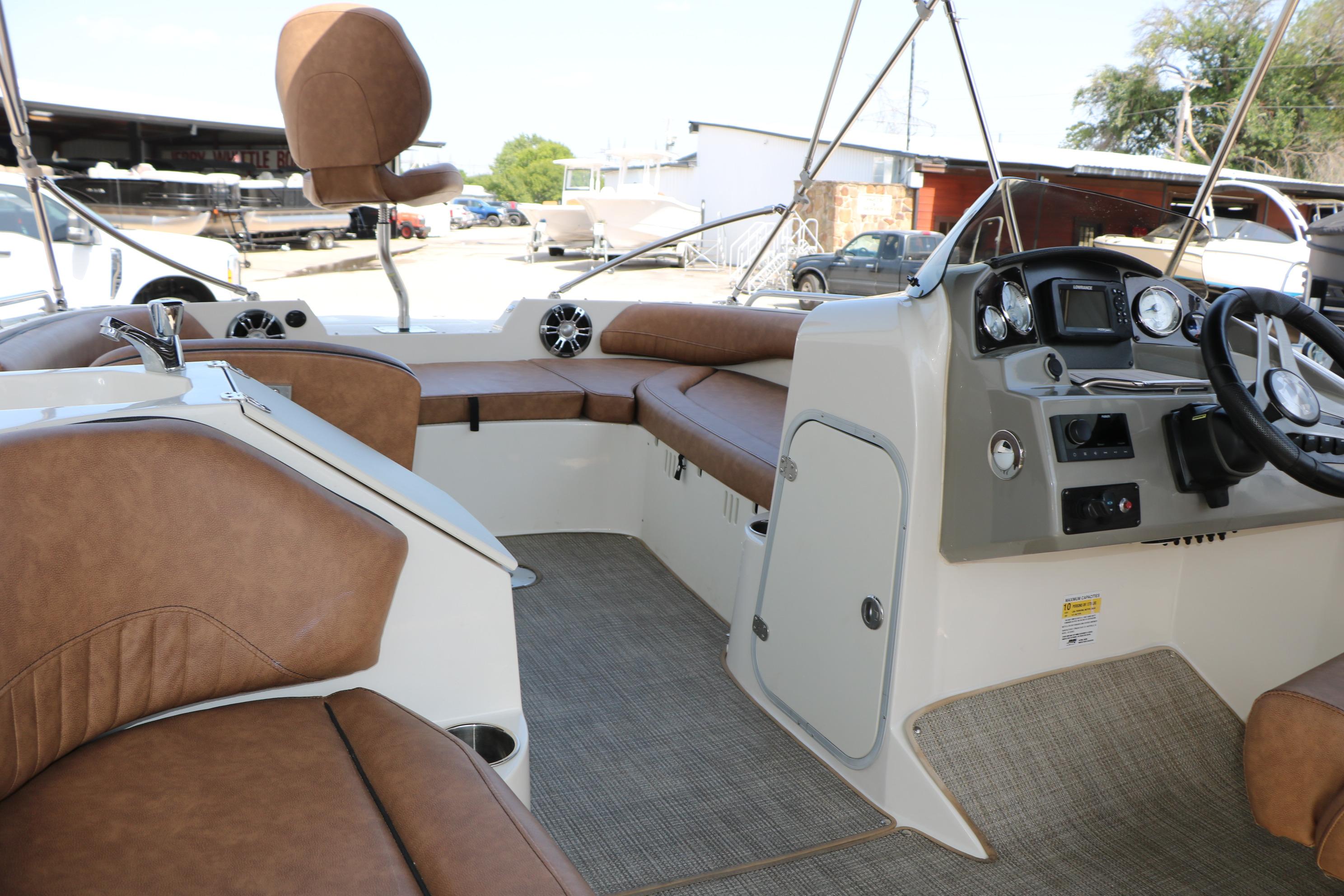 2022 Stingray 192 SC boat interior with brown seating and modern dashboard controls.